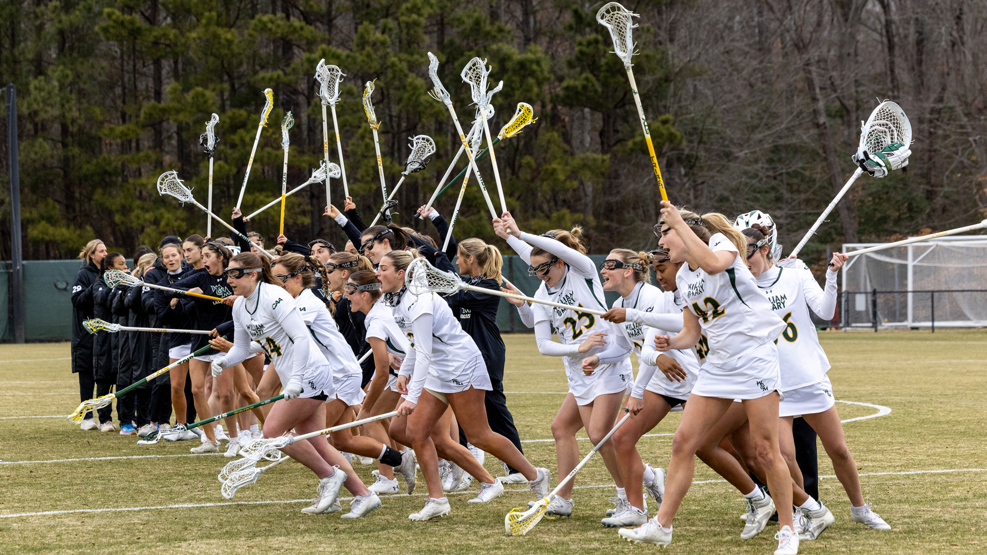 Members of the W&M lacrosse team run off the field after starting lineups. 
