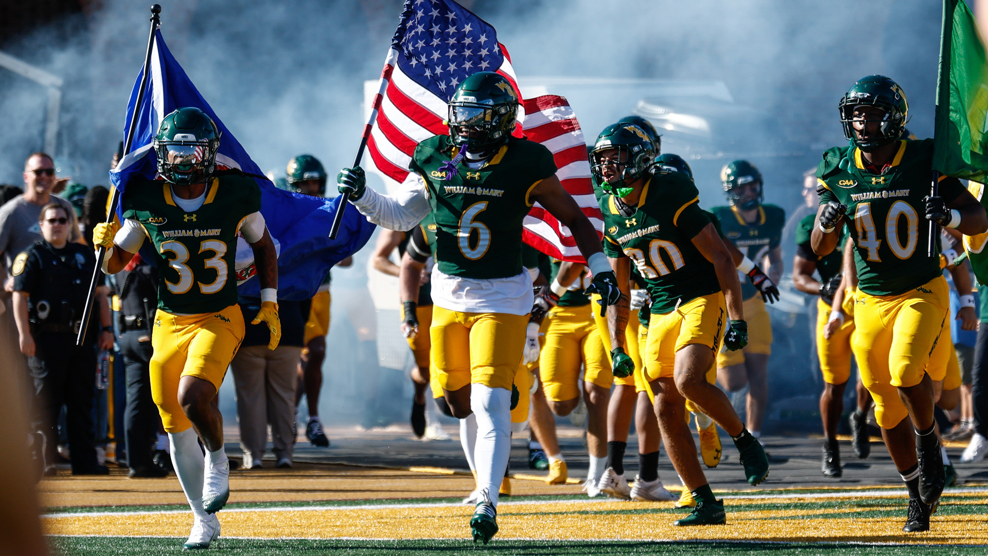Members of the William & Mary football team run on the field prior to a home game at Zable Stadium