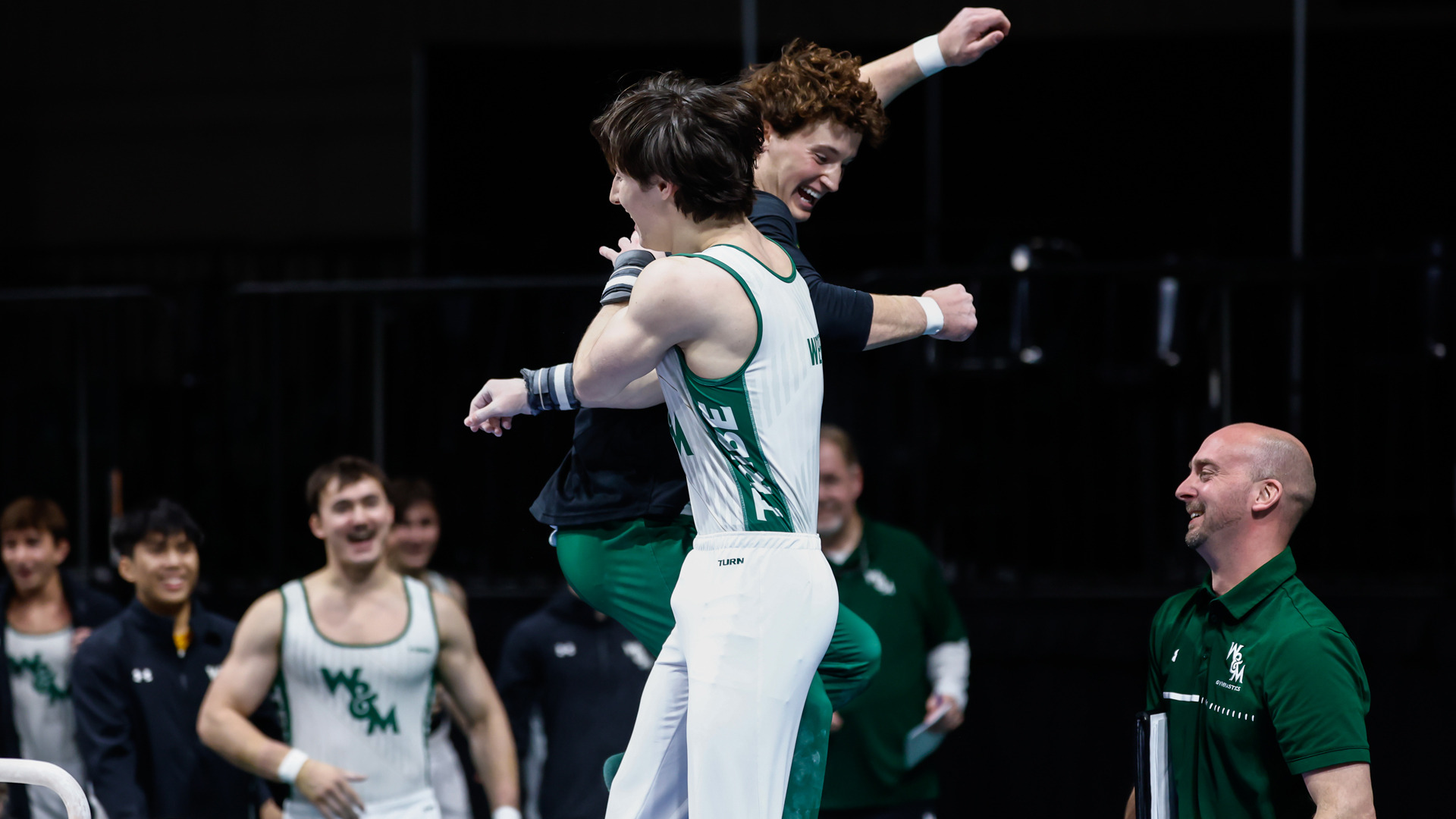 Luke Tully and Michael Weiner celebrate during a home meet at Kaplan Arena