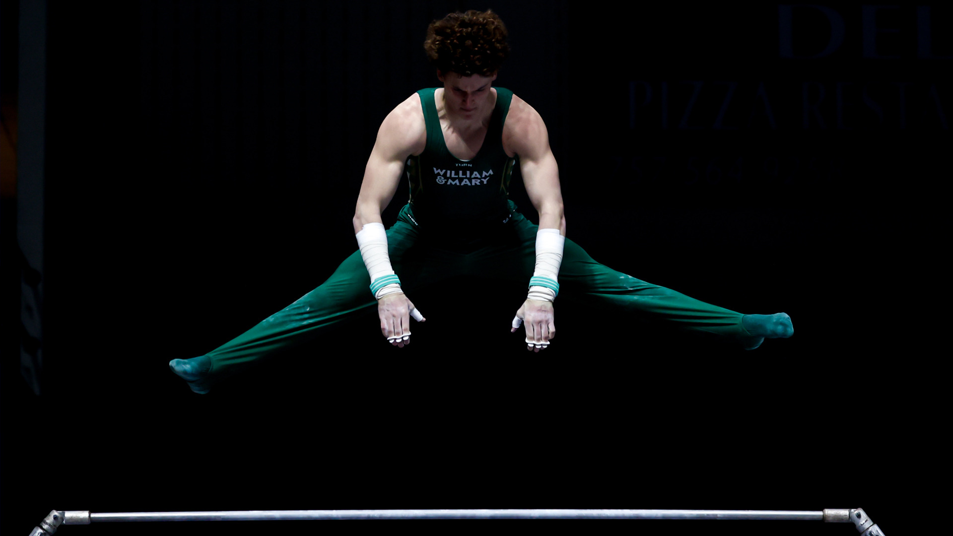 Luke Tully competes on high bar at Kaplan Arena