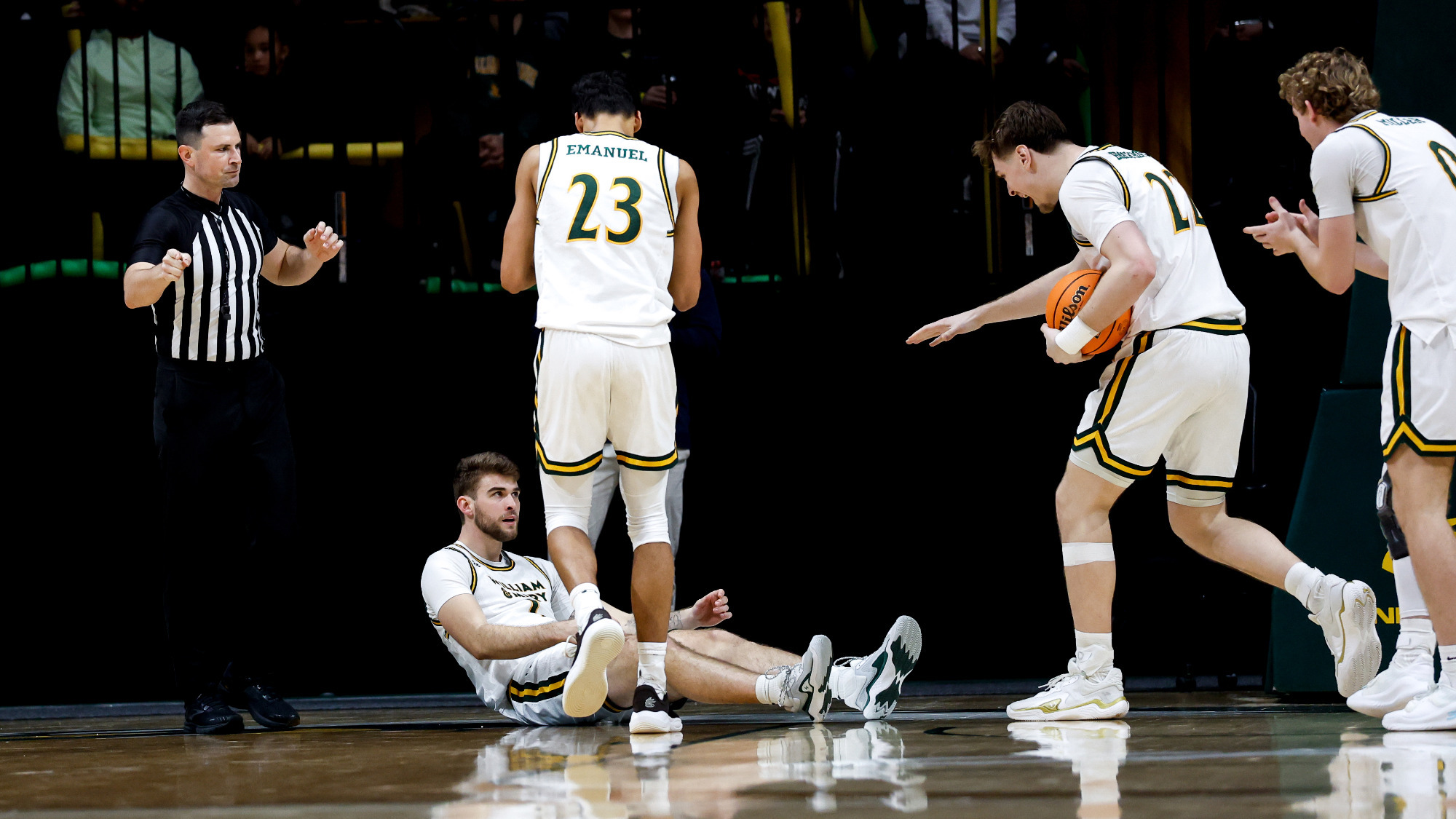 Jo'el Emanuel, Kilian Brockhoff, and Reese Miller celebrate and run over to help up Cade Haskins after he took a charge vs. N.C. A&T.