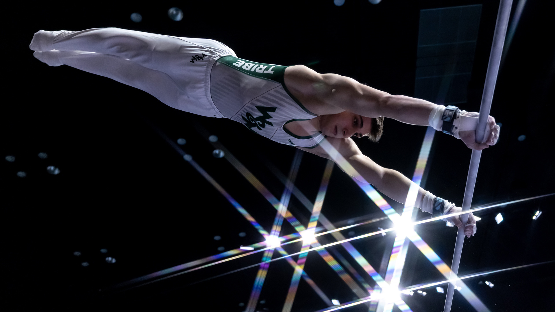 Nicholas Kosarikov compete on high bar during a meet at Kaplan Arena