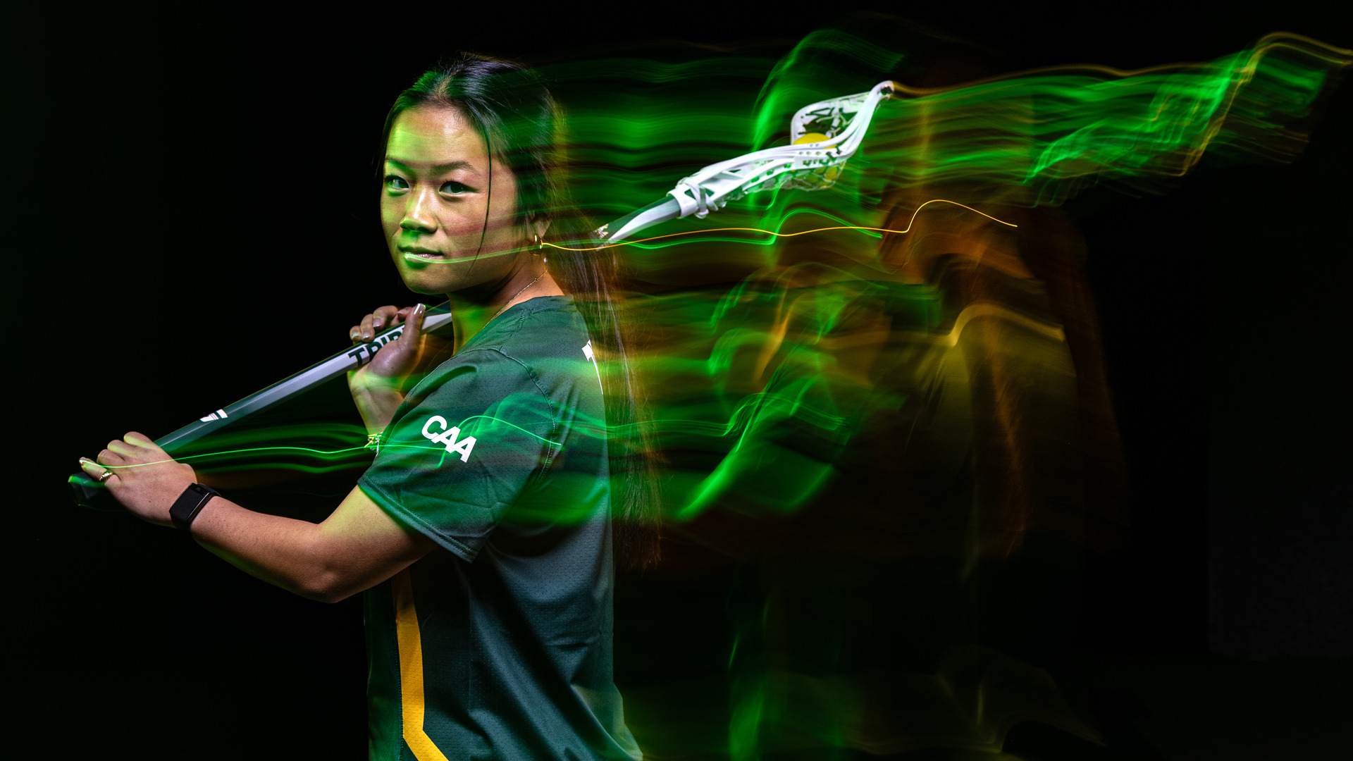 Allison Vigne media day photo with green and gold neon light effects