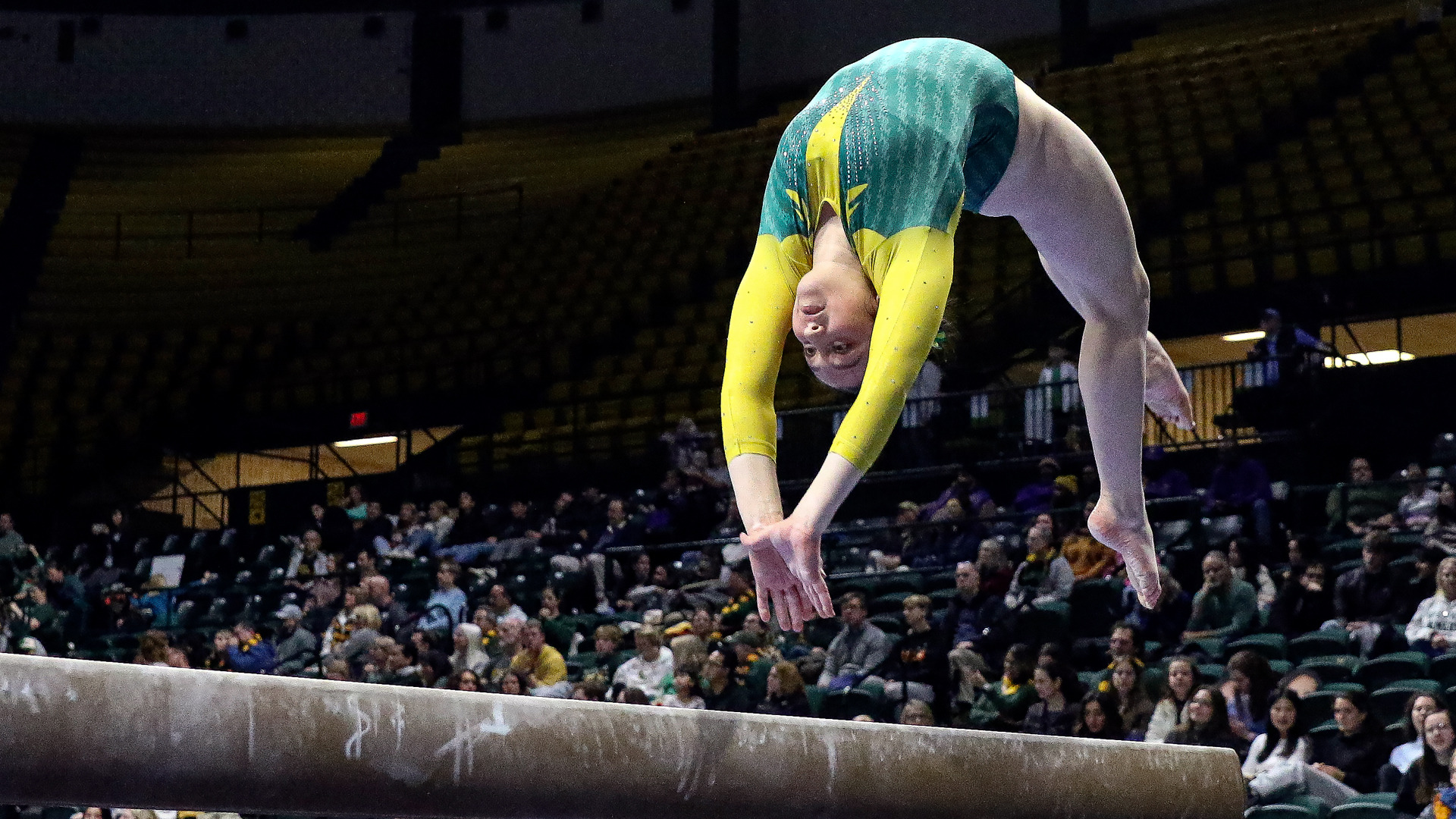 Sophia Summers competes on beam during a meet at Kaplan Arena