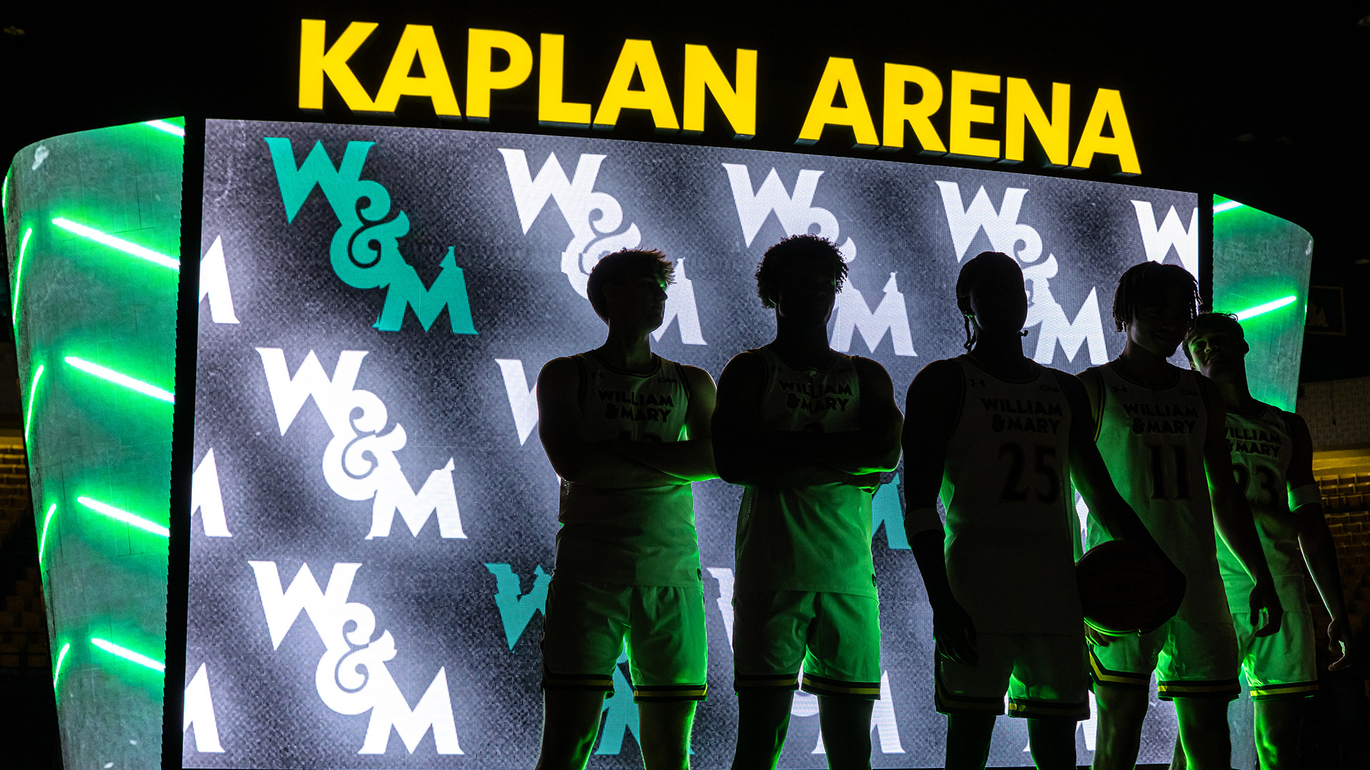 Five Tribe players standed blacked out in front of the Kaplan Arena scoreboard. 