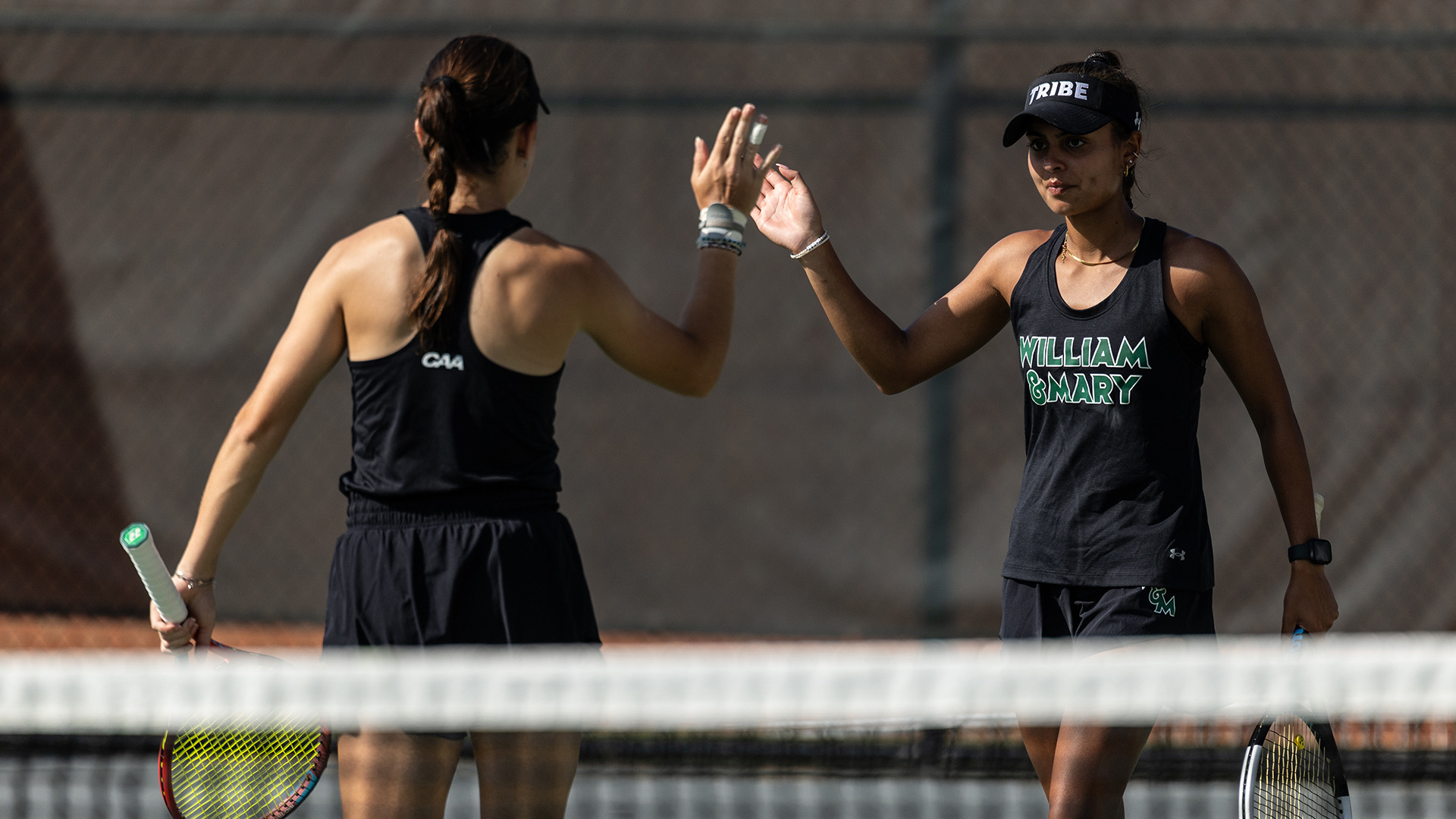 Sia Chaudry and Julia Viesi high five during doubles of the Tribe Invitational.