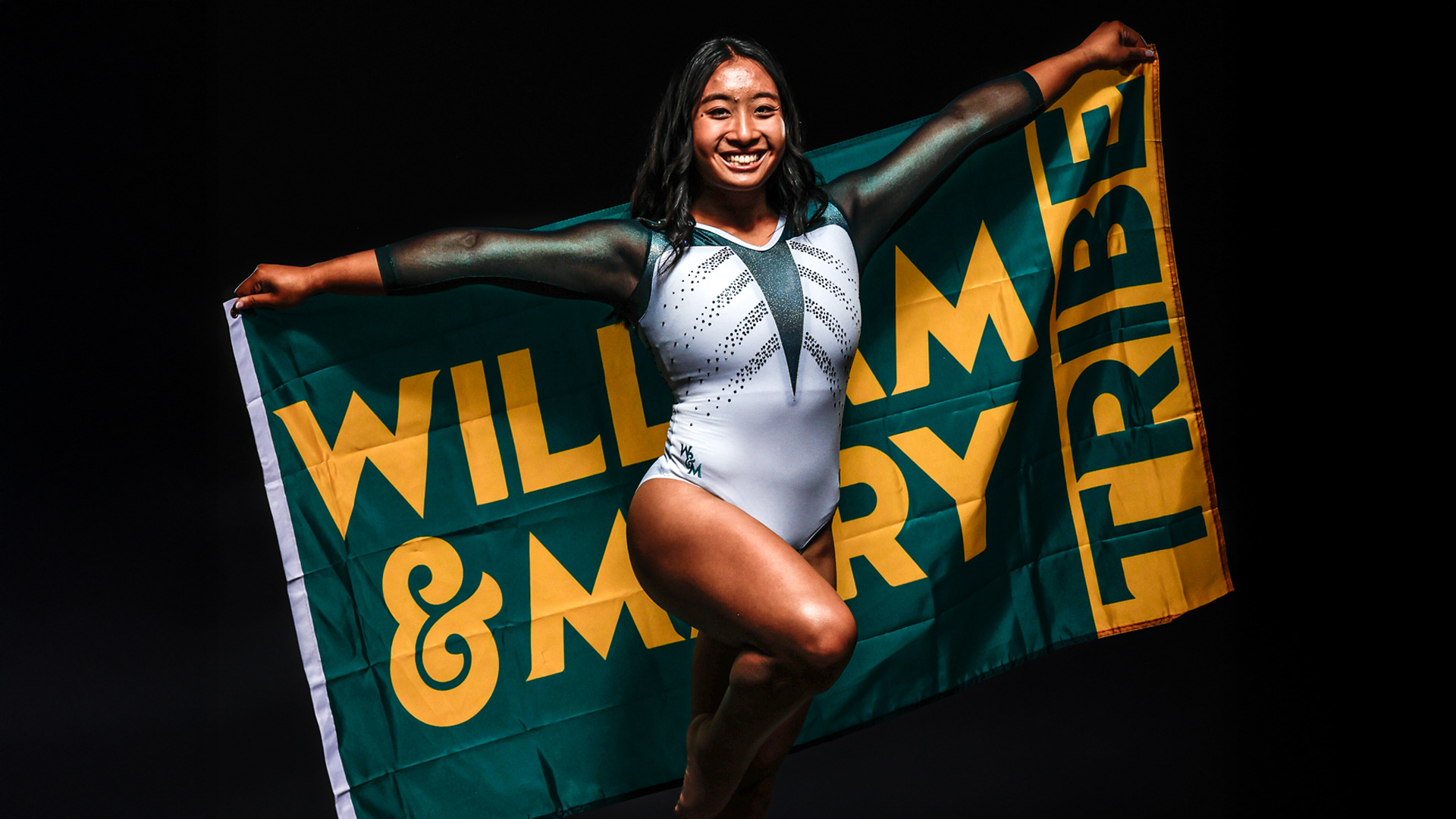 Michelle Ngo holding a William & Mary flag