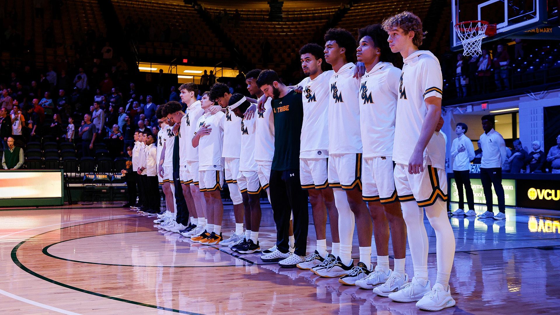 The Tribe stands with arms around each other's shoulders during the national anthem of the Tribe's home game with Radford. 