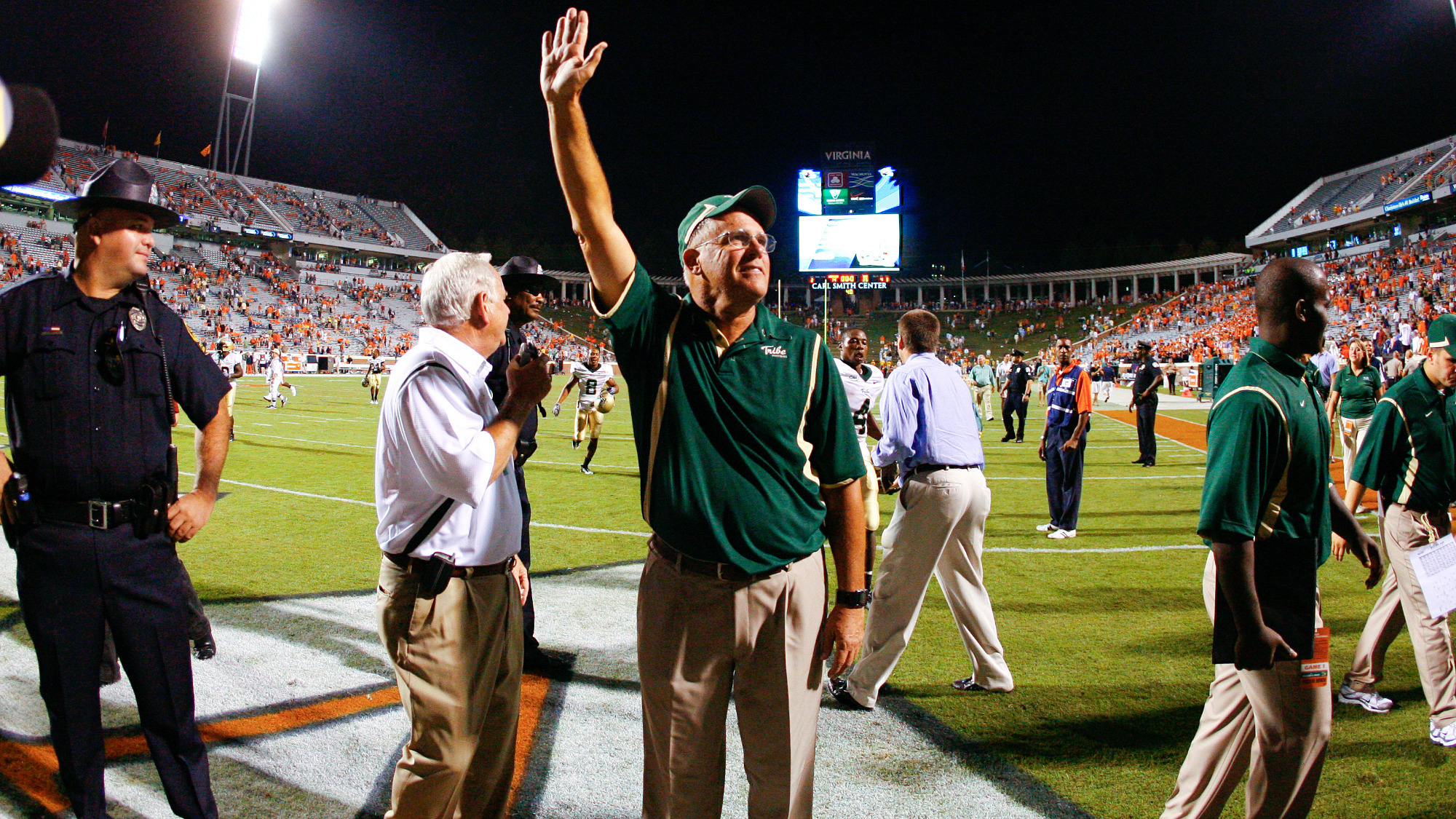 W&M Football Head Coach Jimmye Laycock salutes the crowd after the Tribe's win at Virginia in 2009.
