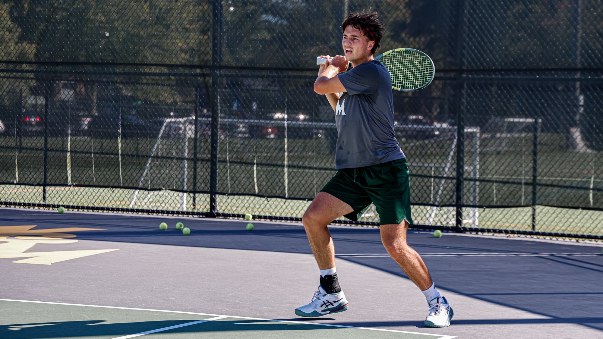 Connor Kruger practicing on the Tribe outdoor tennis courts