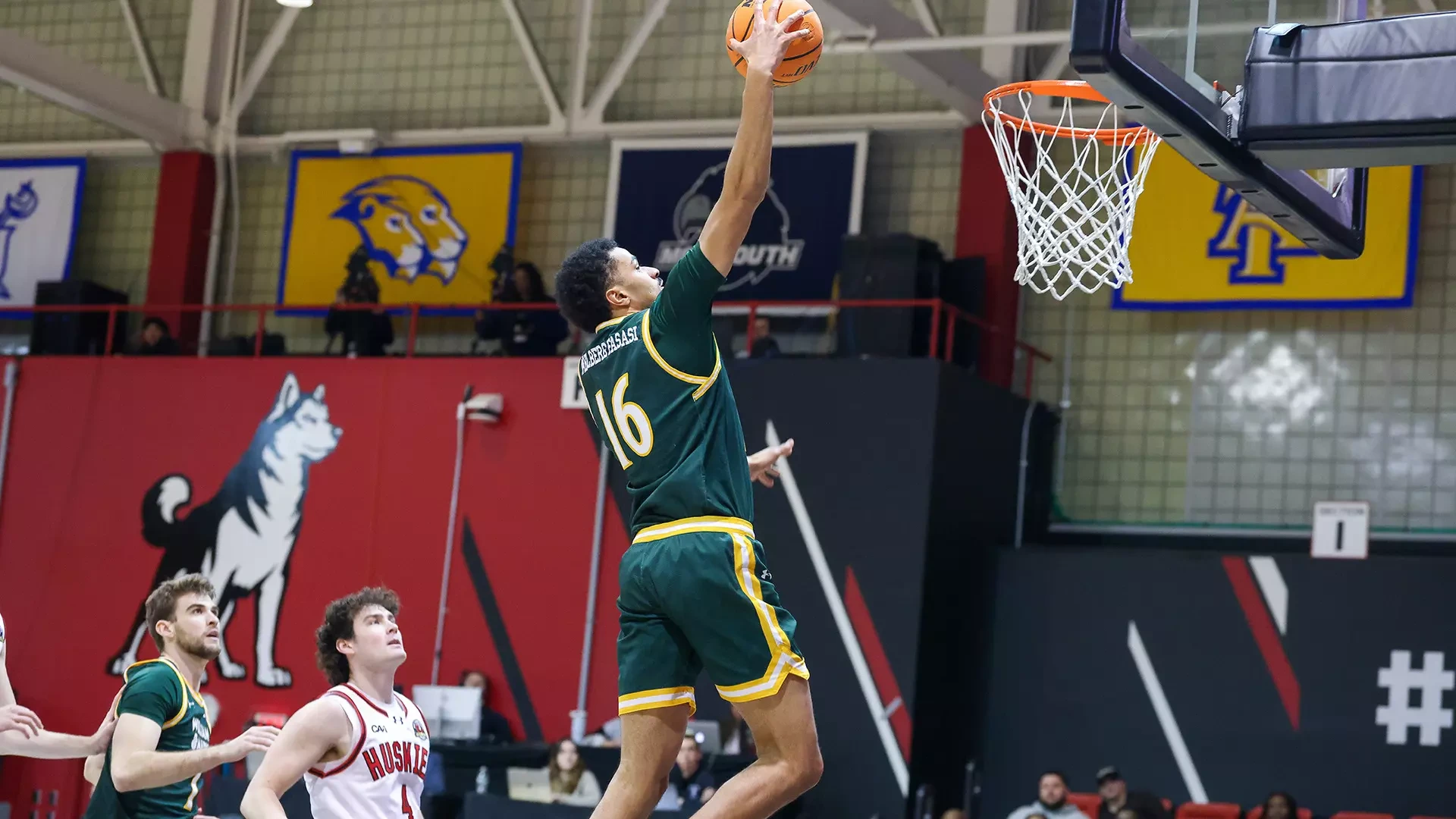 Tunde Vahlberg Fasasi elevates for a dunk on the first play of the game at Northeastern. 