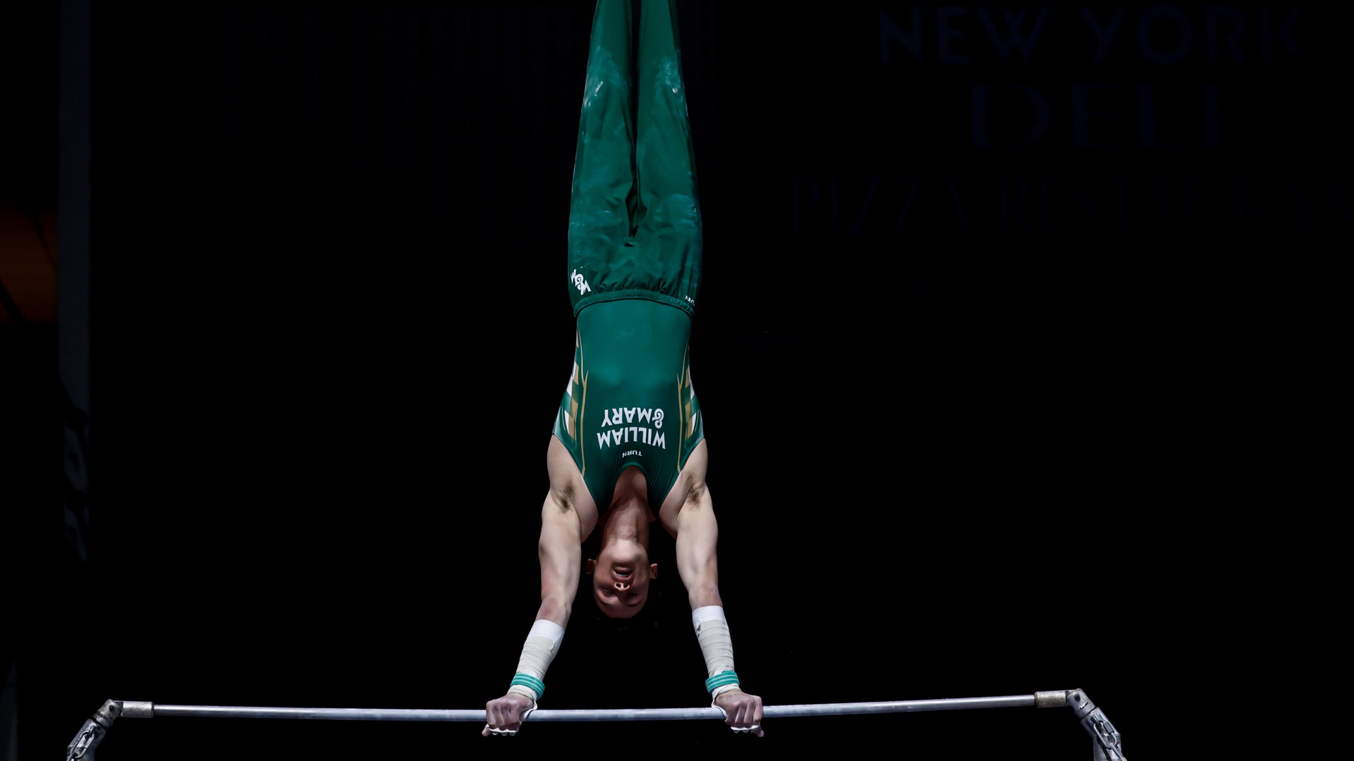 Luke Tully competes on high bar