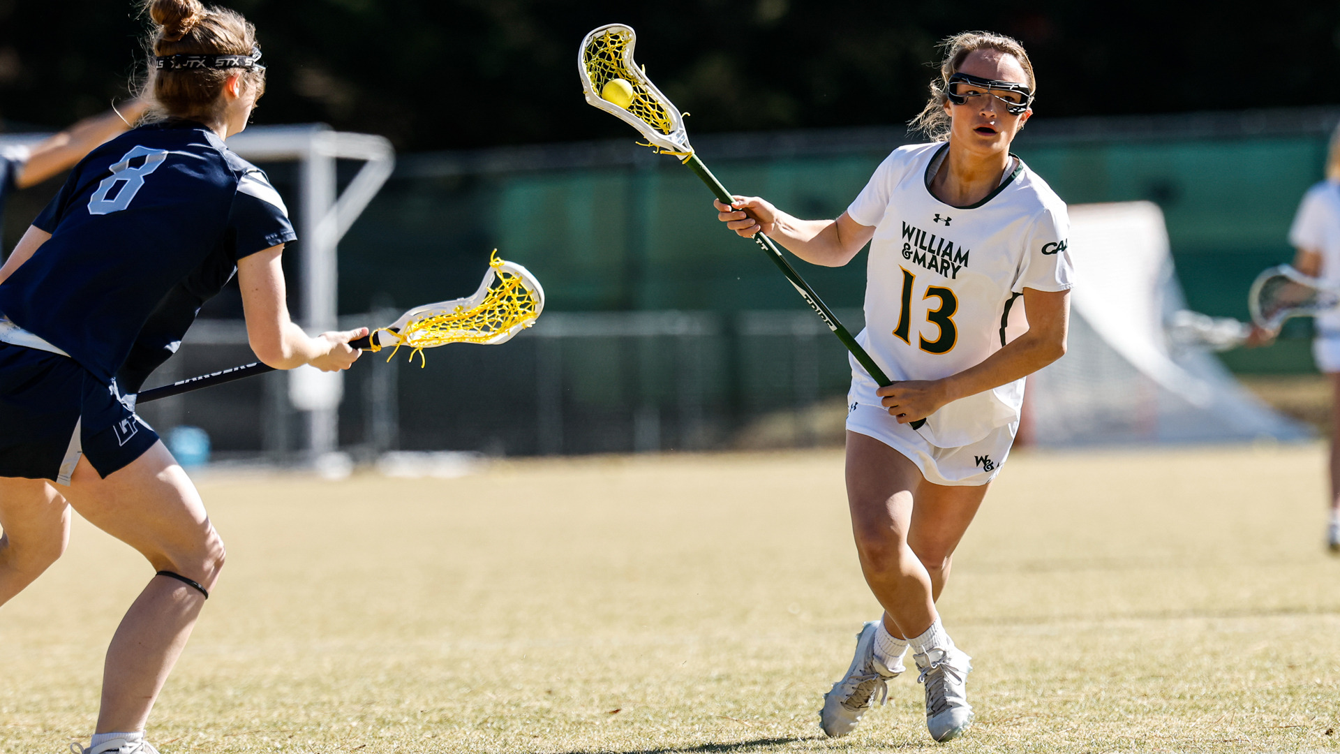 Sydney Witwer runs towards the goal with the ball in a home game versus Longwood.