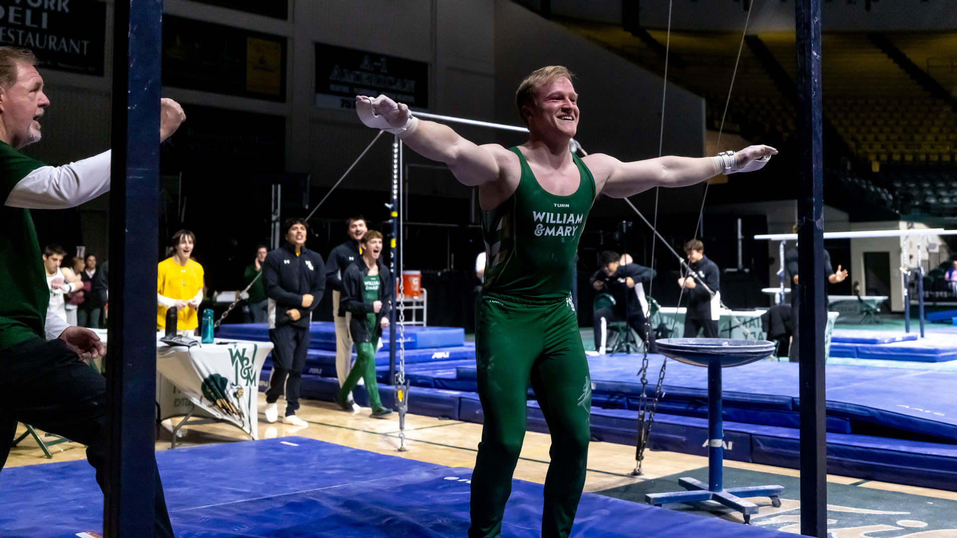 Jonathan Irwin smiles after a successful rings routine at Kaplan Arena