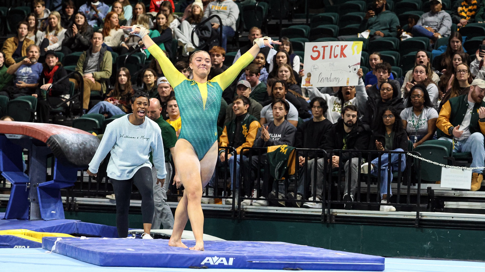 Hannah Burke competes on floor during a gymnastics meet at Kaplan Arena