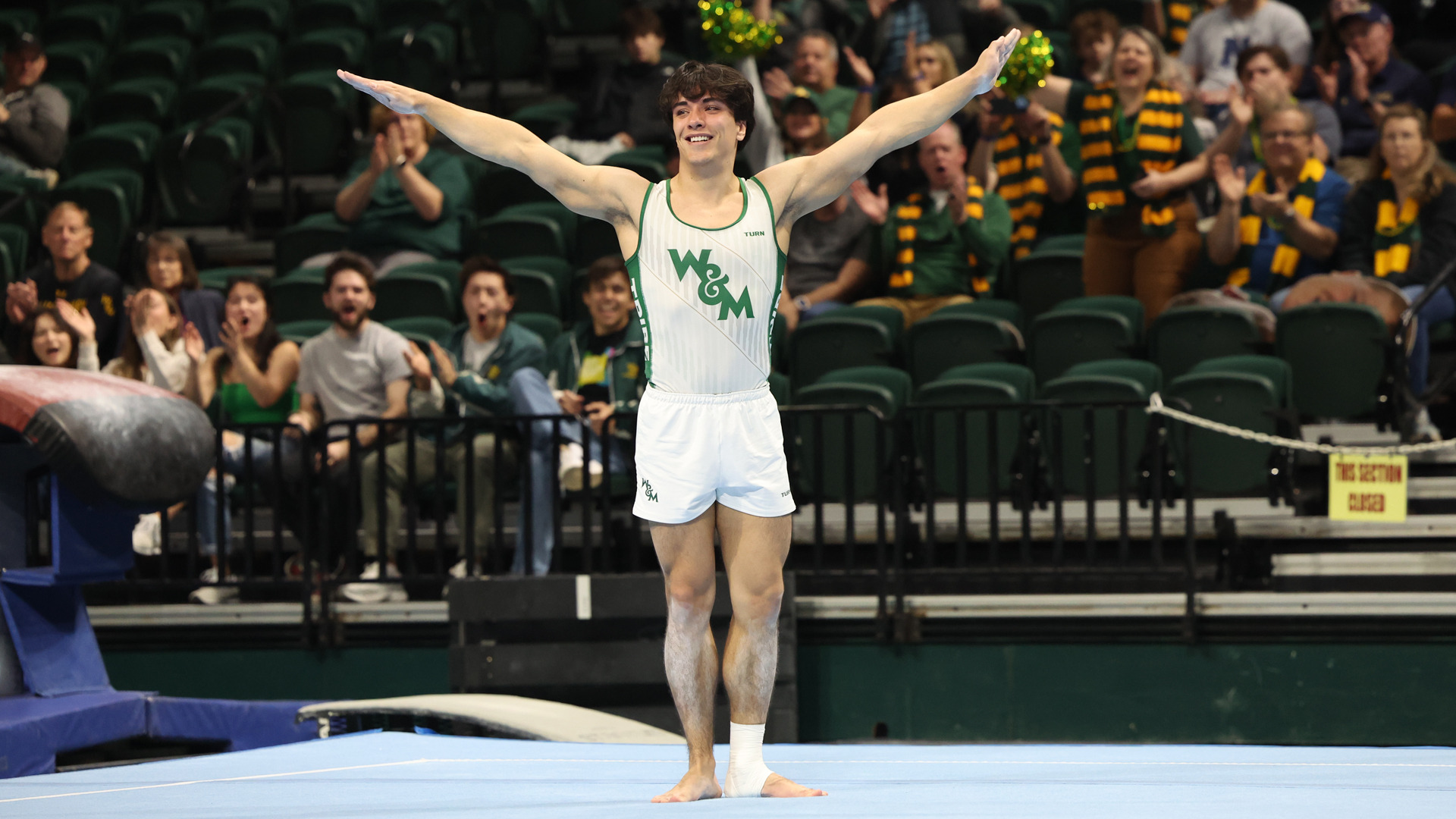 Niko Greenly competes on floor during a meet at Kaplan Arena