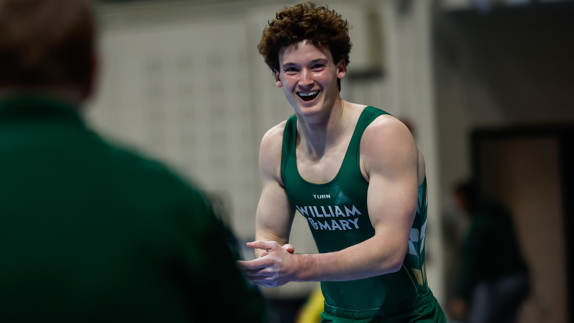 Luke Tully celebrates after a floor routine during a meet at Kaplan Arena