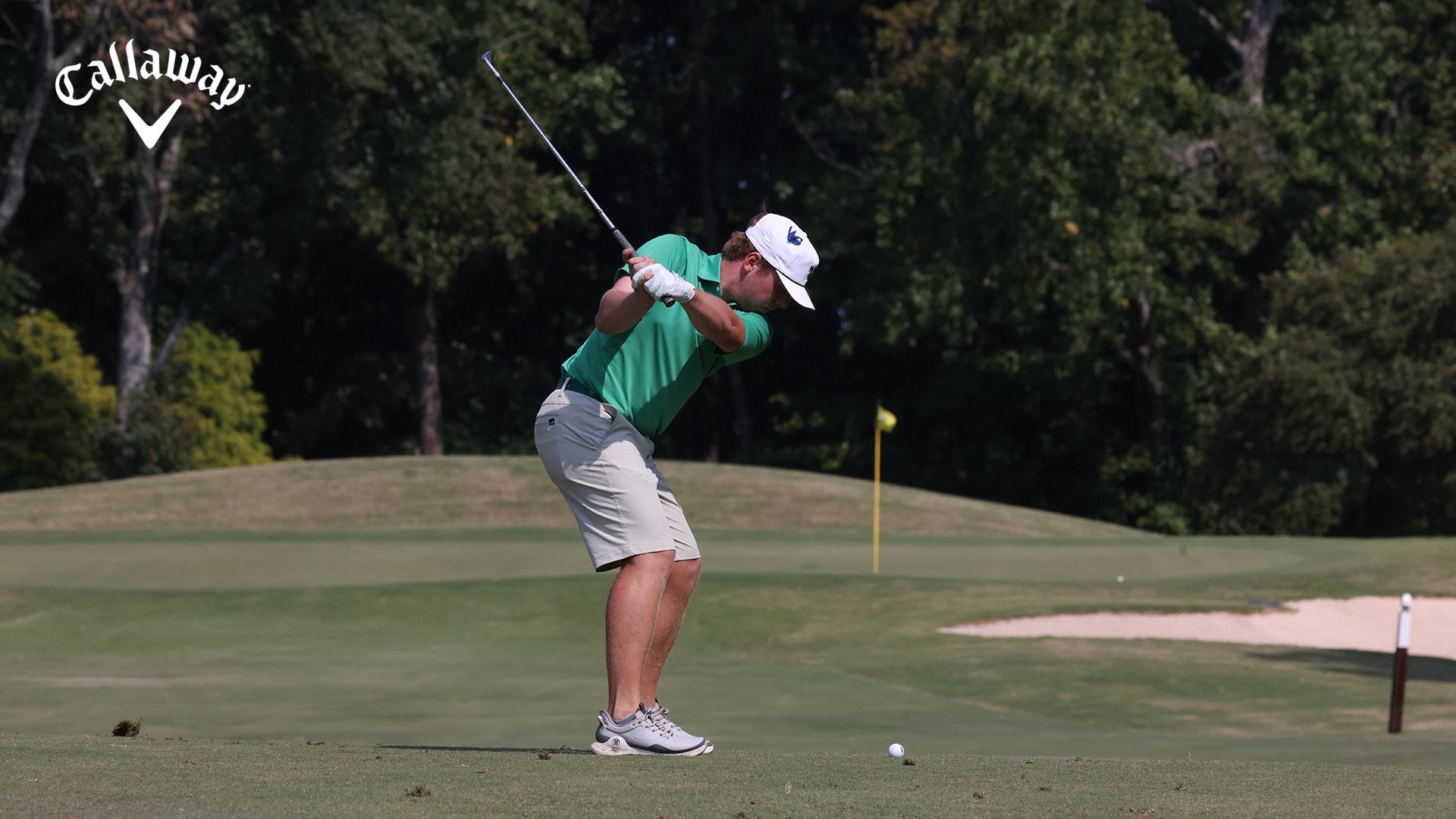 Preston Burton gets ready to start his downswing on a approach shot with the green in front of him at the UNCG event during the 2025 fall season. 