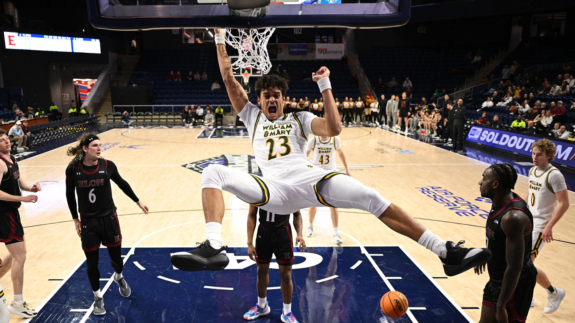 Jo'el Emanuel hangs on the rim and yells after a dunk in the second half of the CAA Second Round win over Elon. 
