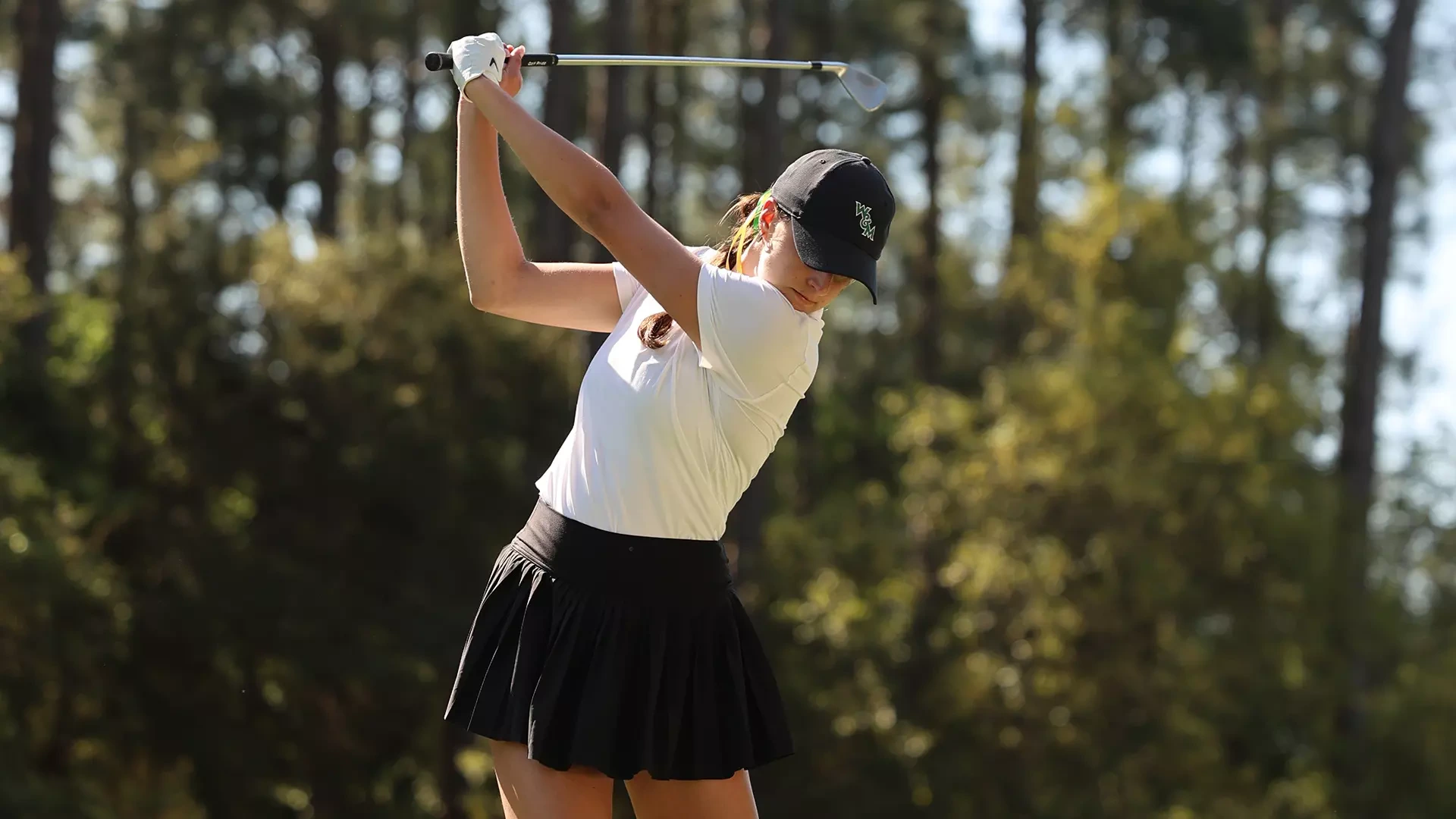 Reagan Garnsey is in her backswing with an iron off a tee in the opening round of the CAA Championships. She carded a 75 (+3) to sit in 12th place. 