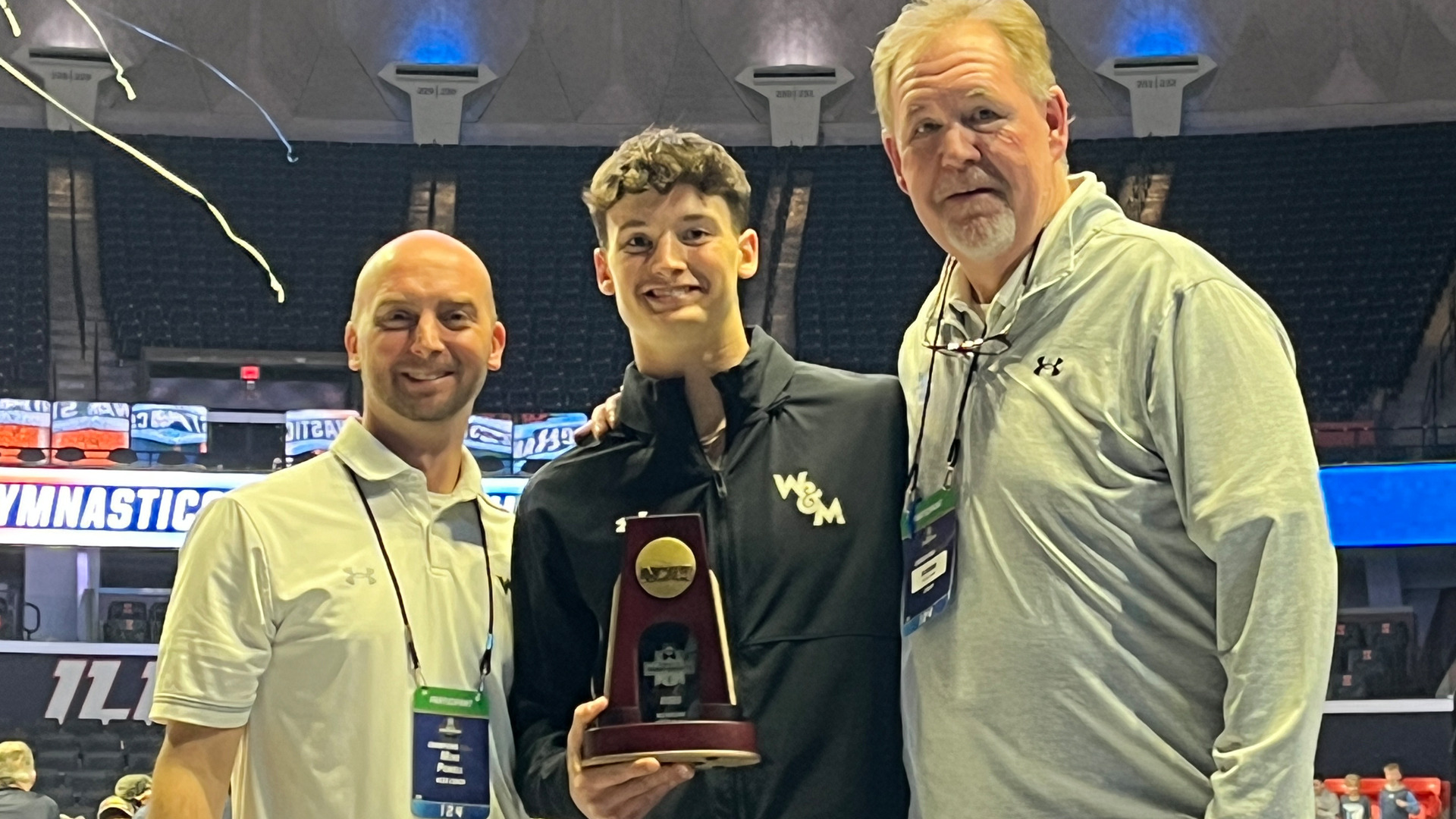 Luke Tully with his NCAA All-America award next to head coach Mike Powell and assistant coach Bo Morris