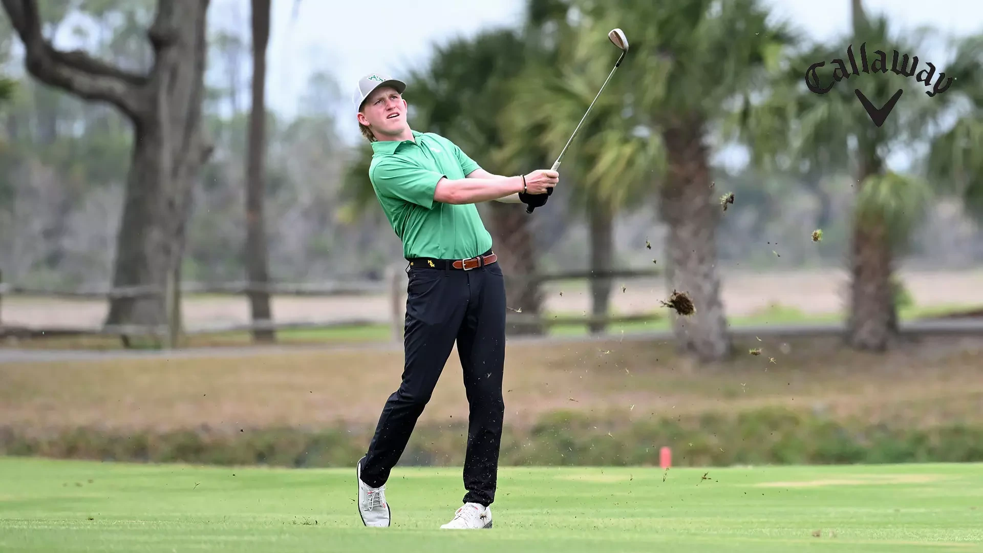 Talon Dingledine follows through short and watches his shot with an iron from the fairway in the second round of the CAA Championships. Dingledine shot a second round 72 and sits in the top 10 through 36 holes. 