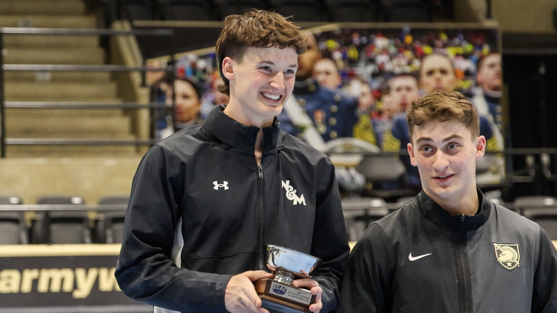 Luke Tulley accepts an all-conference award at the ECAC Championship meet