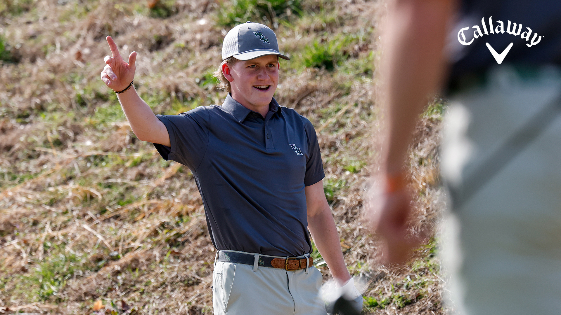 Talon Dingledine smiles and raises his arm in acknowledgement after holing out a chip during a practice round at the Golden Horseshoe Gold Course. 