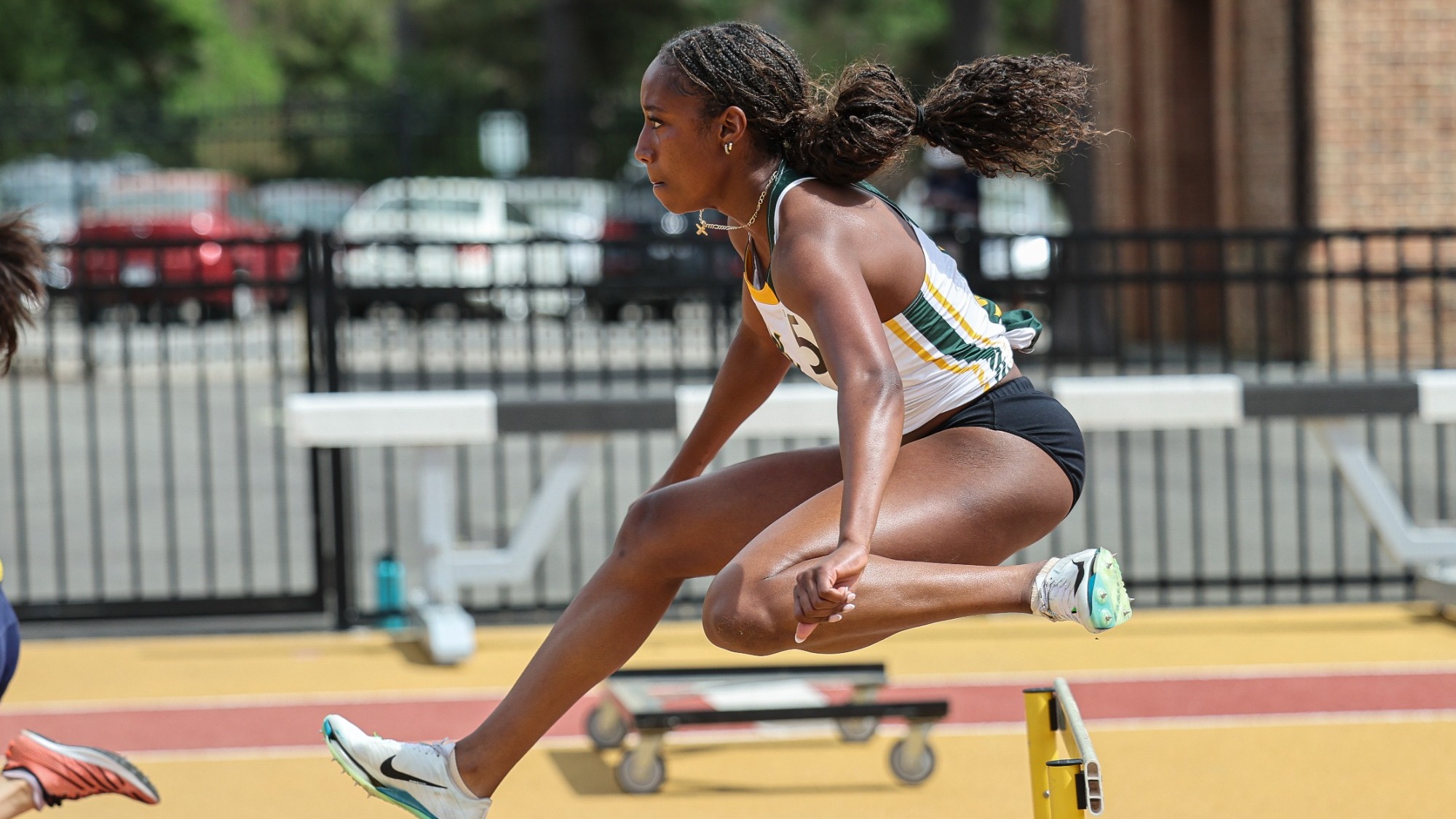 Kennedy Reynolds leaping over a hurdle
