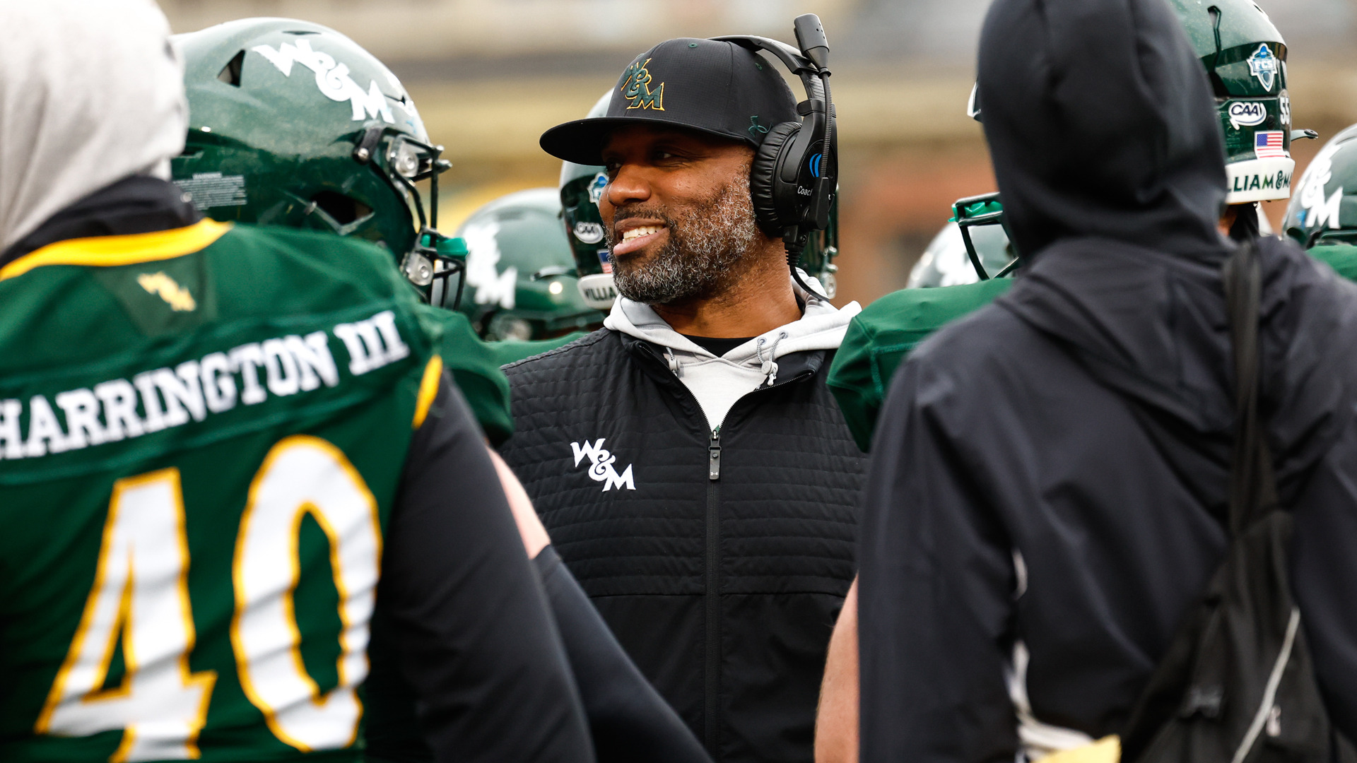 Darryl Blackstock smiles as he coaches during a game at Zable Stadium