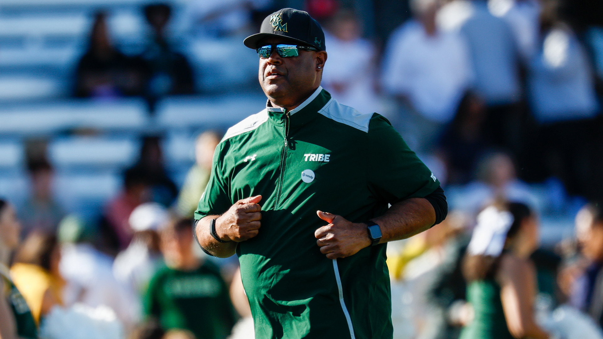 W&M Football Head Coach Mike London runs on the field at Zable Stadium