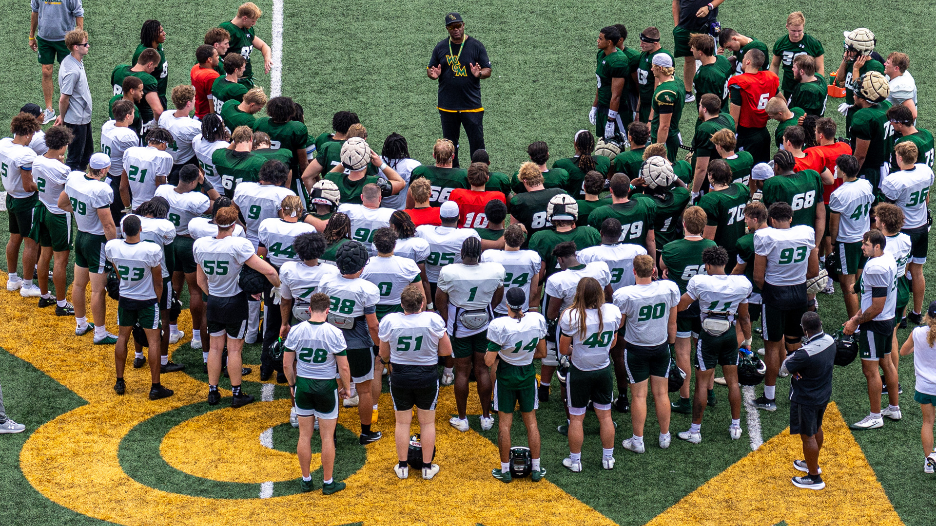 W&M Football Head Coach Mike London speaks to the team at midfield following a preseason practice at Zable Stadium on Aug. 1, 2026.