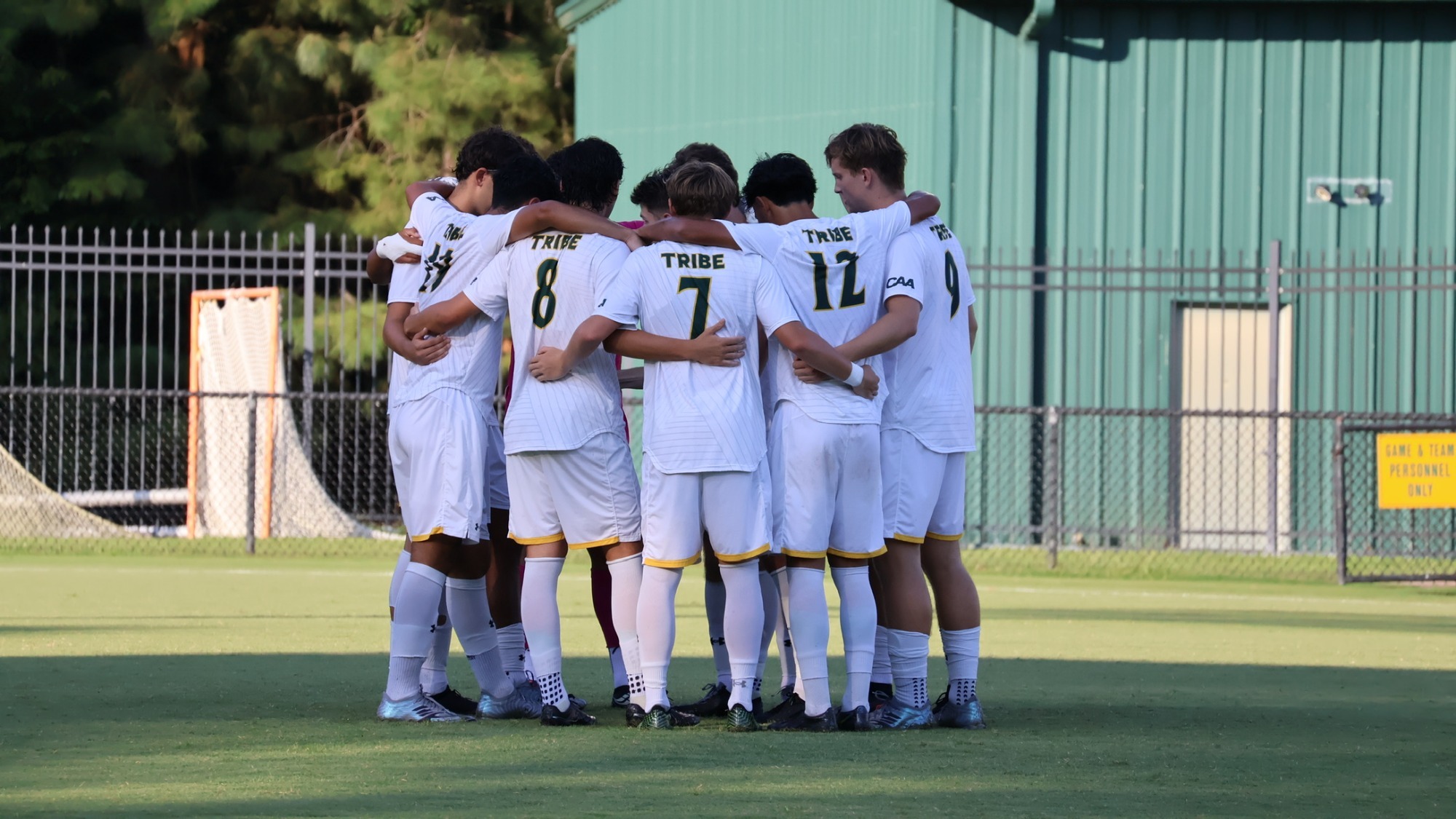 Men's soccer huddling up together before the game vs. Radford