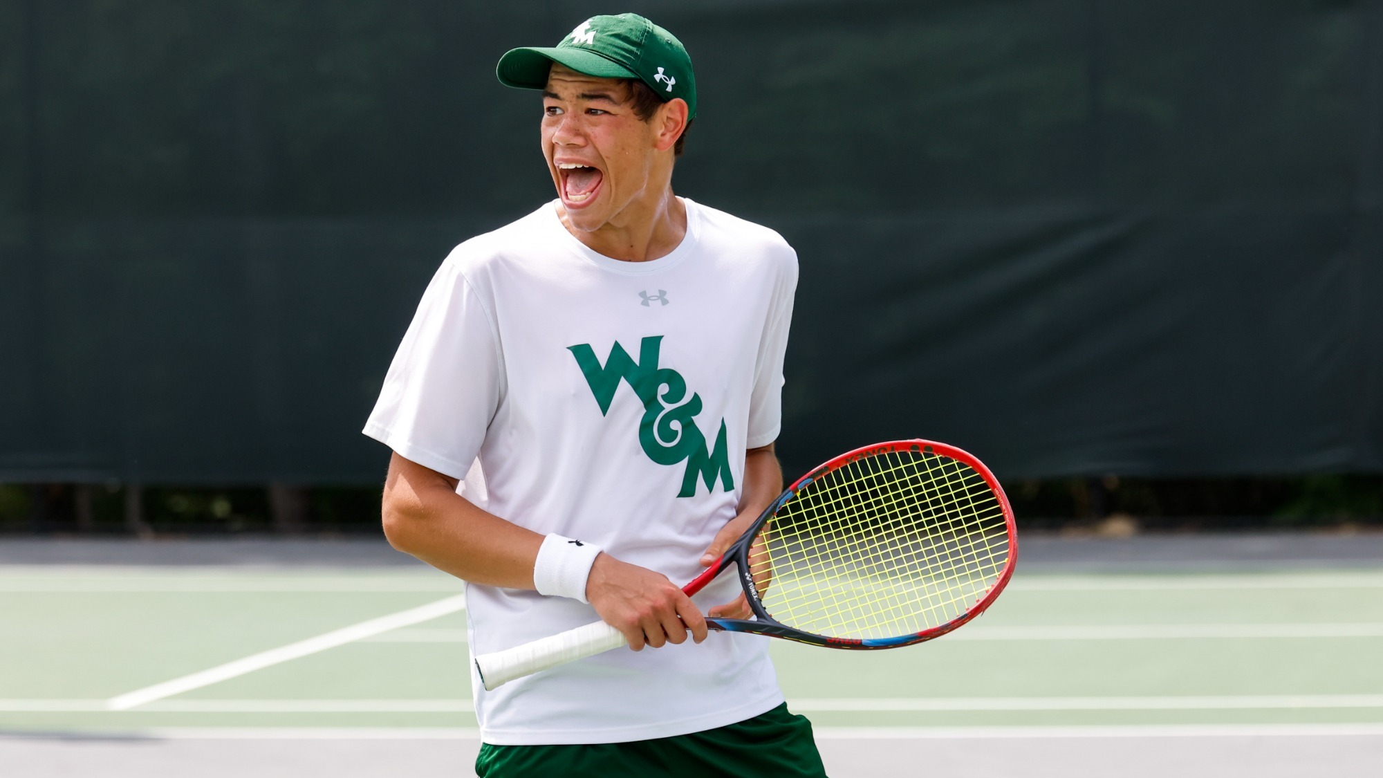 Dylan Chou competing for W&M men's tennis