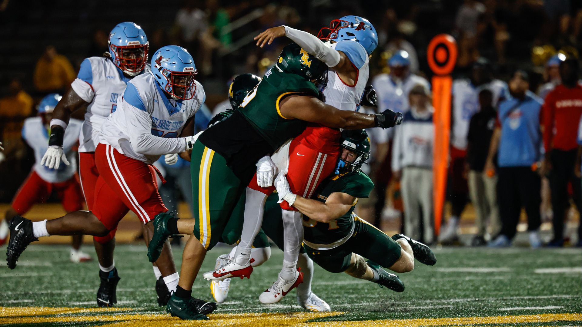 Ty Gordon tackles Delaware State's quarterback as he's making a pass attempt