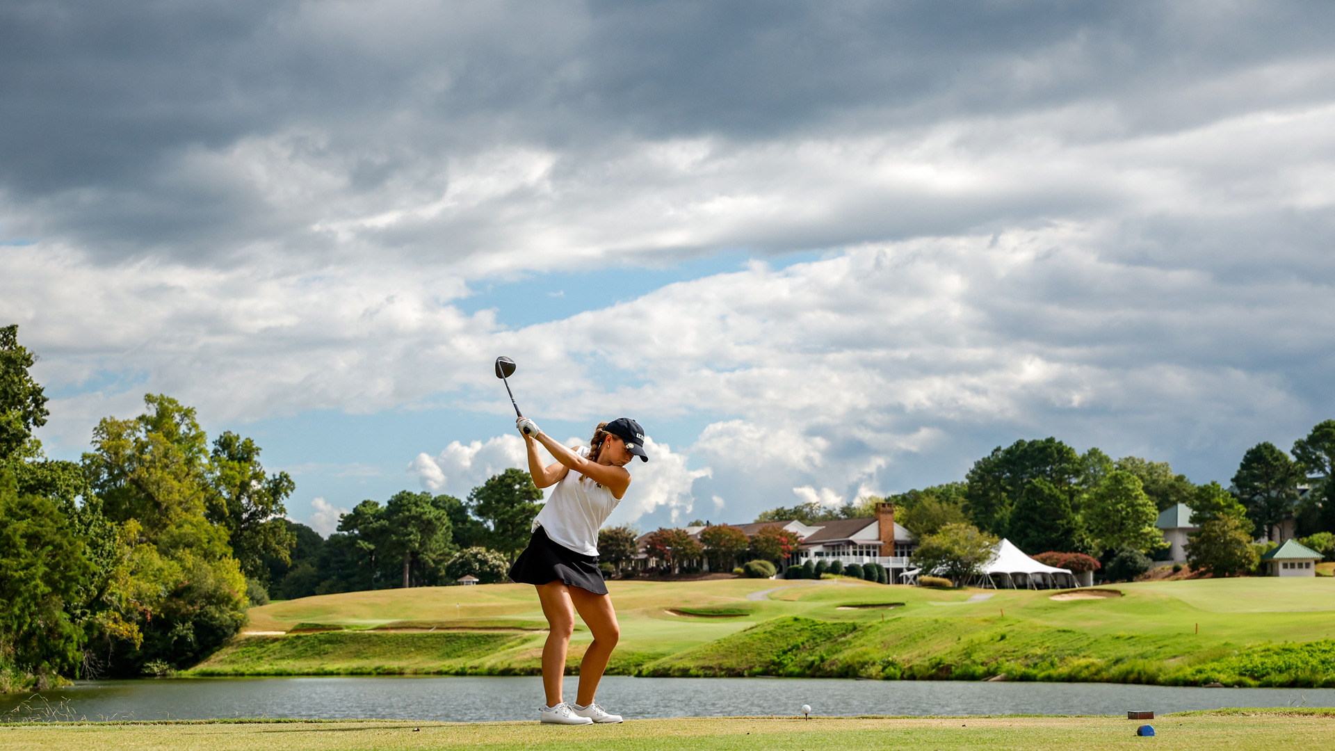 Abigail Avallone takes a practice swing on the t-box of the 18th hole on the Kingsmill River Course.
