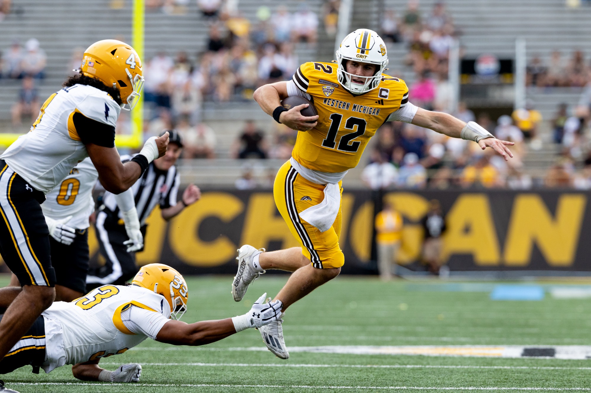 Broc Lowry runs past a KSU tackler.