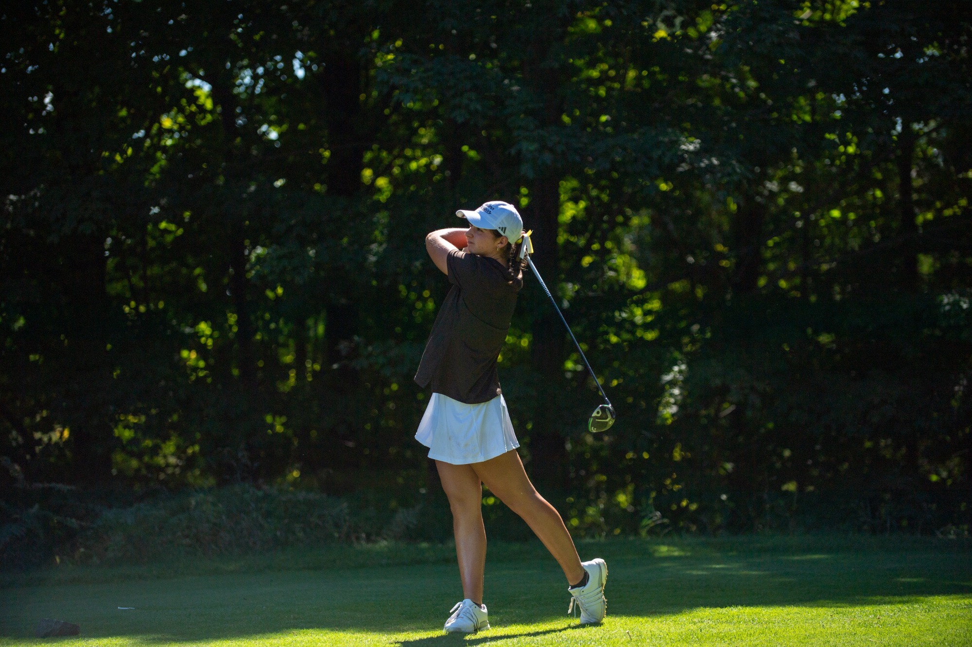 Sophomore Lea Lemieux finishes a drive at the A-Ga-Ming Invitational