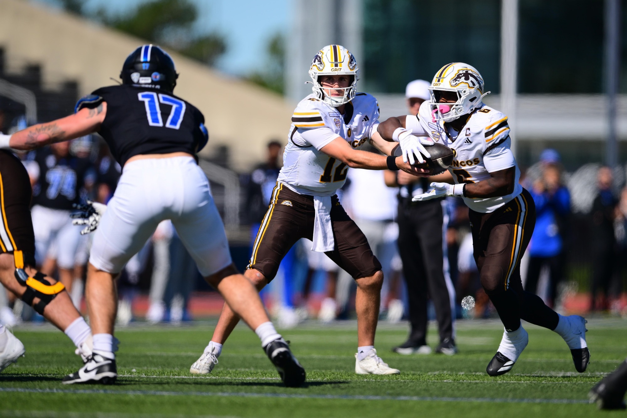 Broc Lowry hands the ball off to Jaden Buckley in WMU's game at Buffalo.