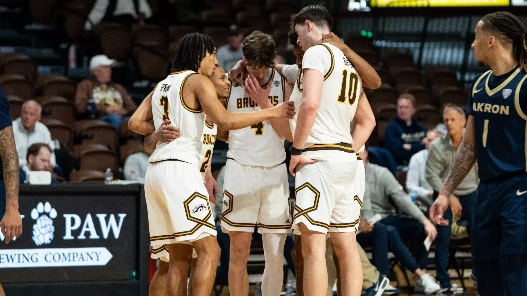 WMU Men's Basketball huddles up during a timeout against Akron