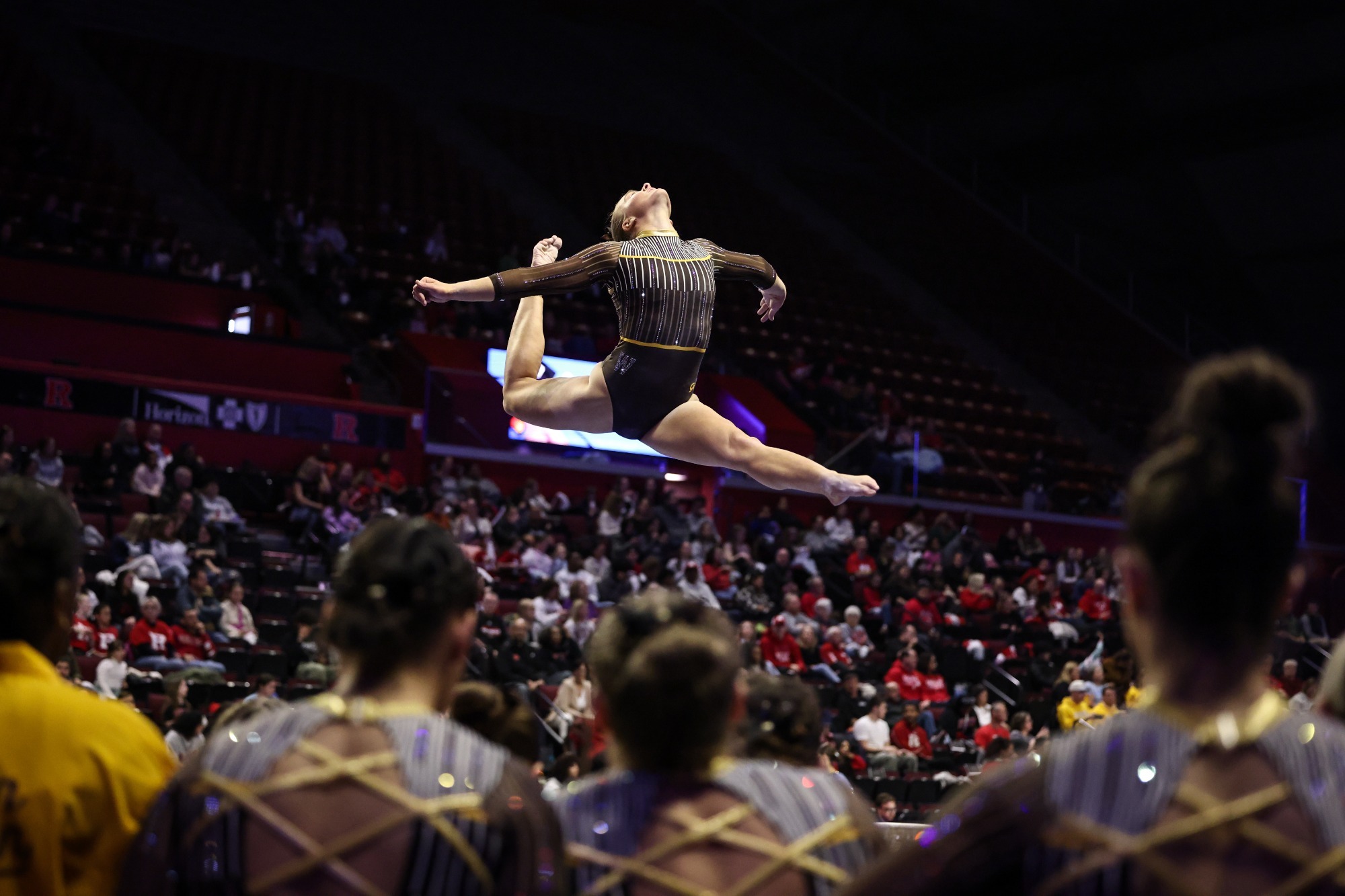 A WMU Gymnast leaps along the beam