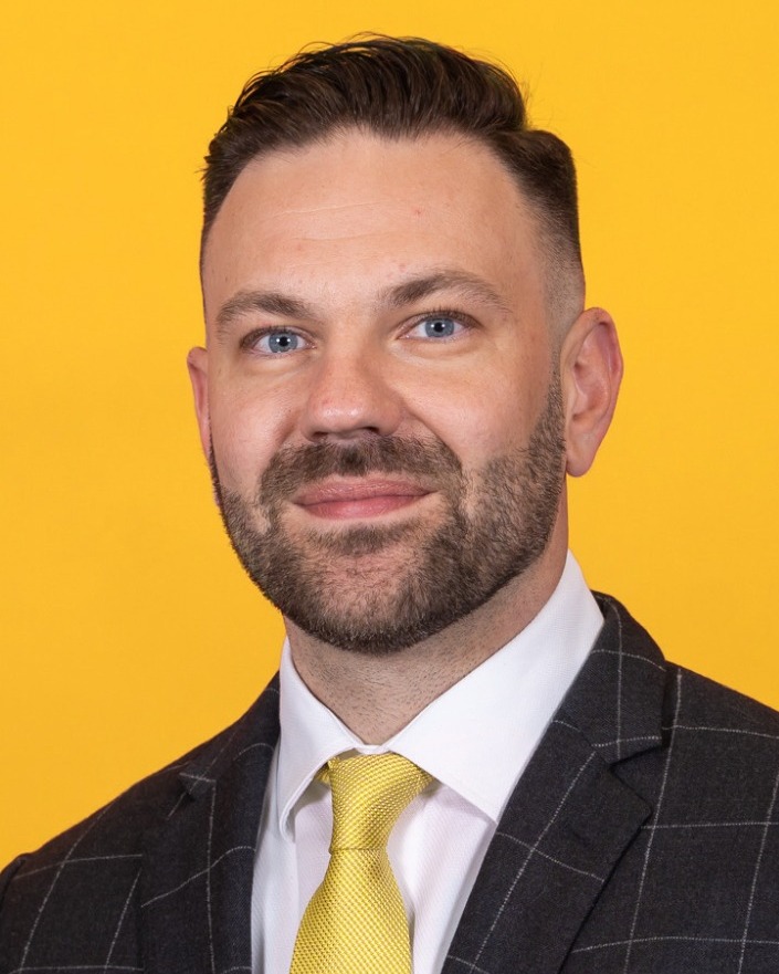 Head shot of assistant men's basketball coach Dustin Yoder