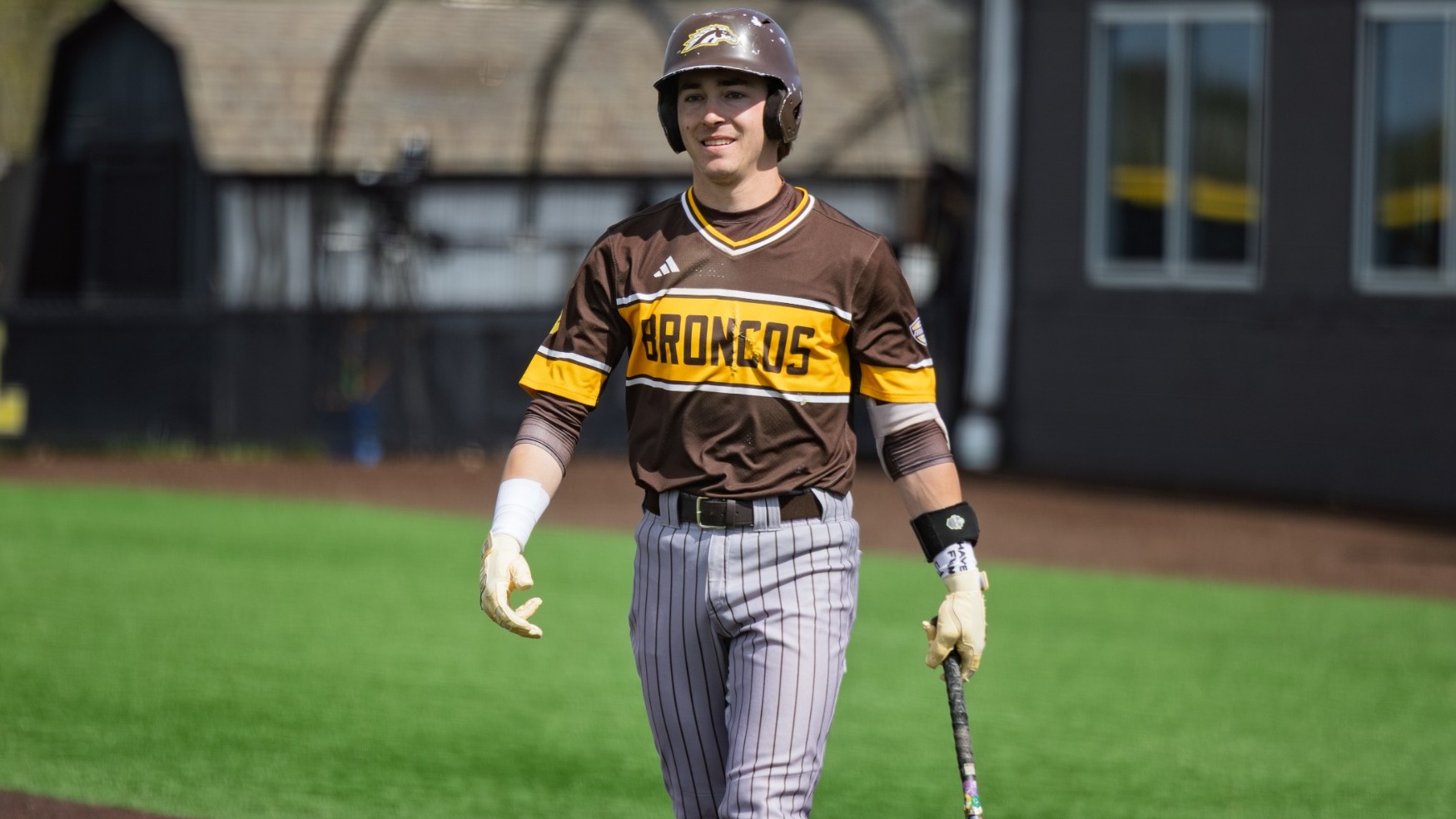 Drew Howard picks up a bat after scoring against Valparaiso