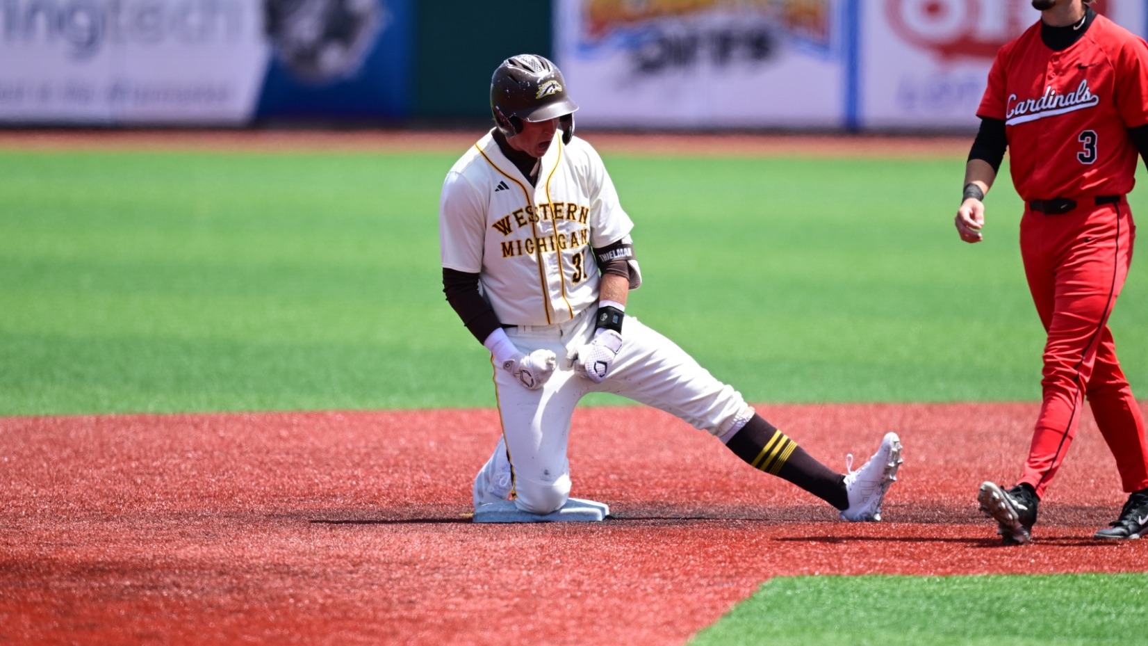 Avery Thielman celebrates at second base after hitting a go-ahead double against Ball State in the MAC Tournament