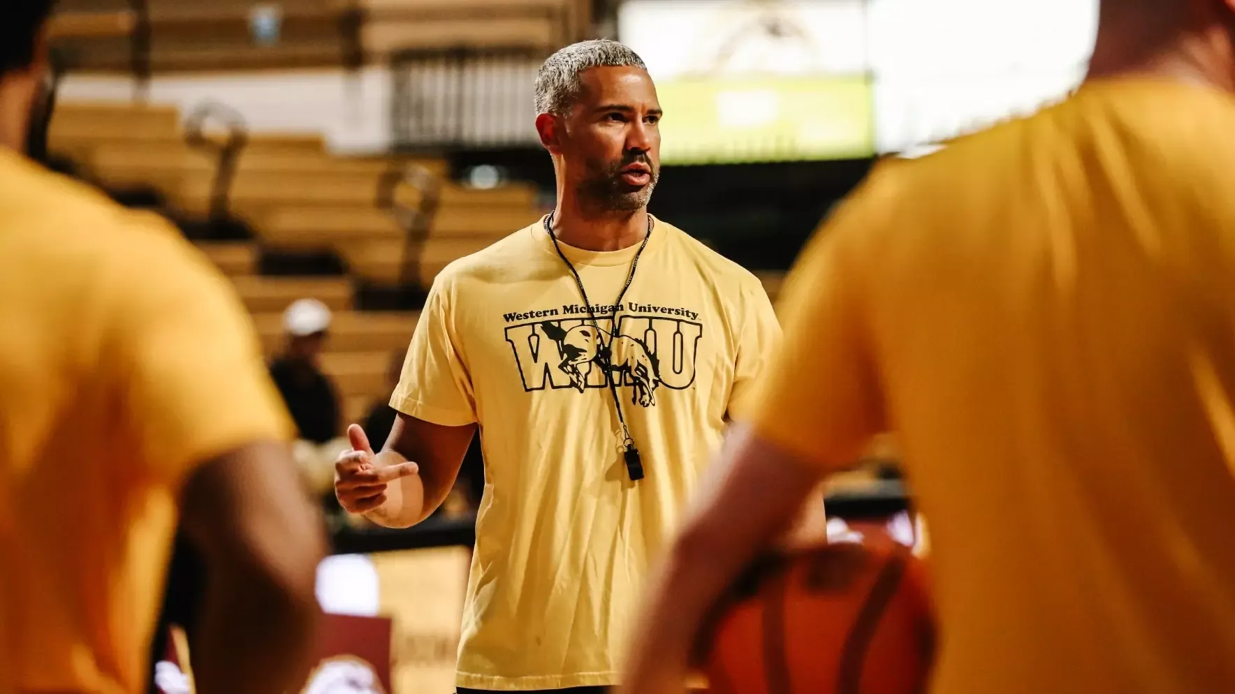New WMU men's basketball head coach Kahil Fennell instructs his team at its first summer workout session