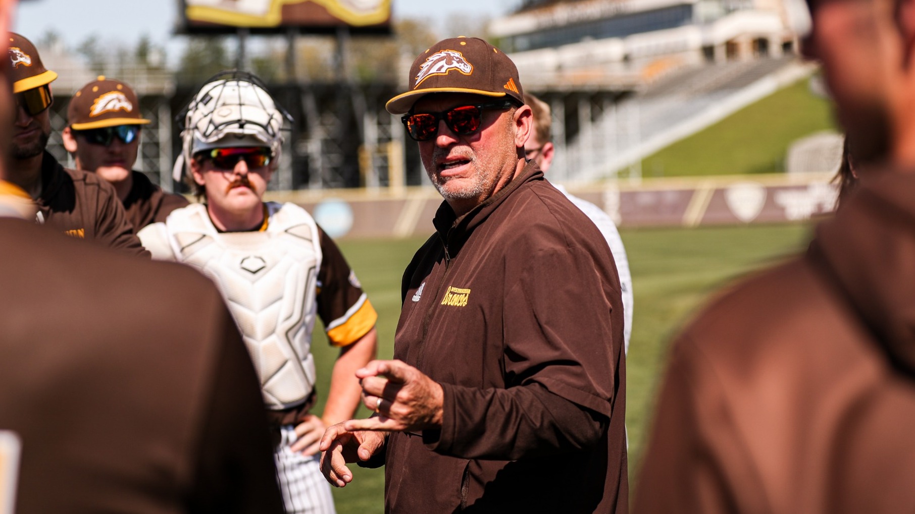 Coach Billy Gernon addresses his team before they take the field