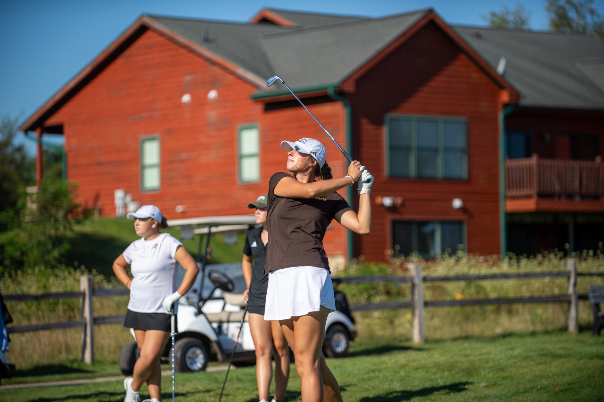 Annie Flavin watches a drive at the A-Ga-Ming Invitational 