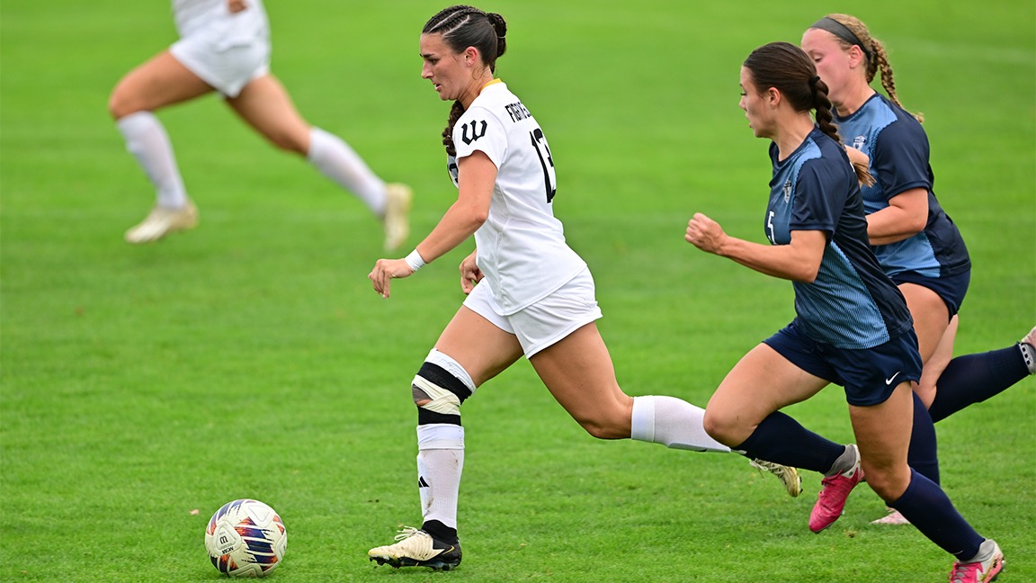 Josie Bencic runs away from a pair of defenders