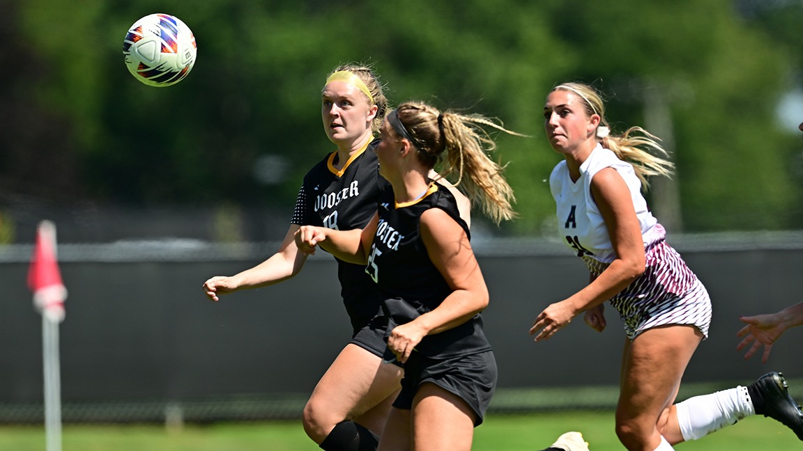 Caitlin Martin and Annie Henegar look at a ball in the air hoping for possession