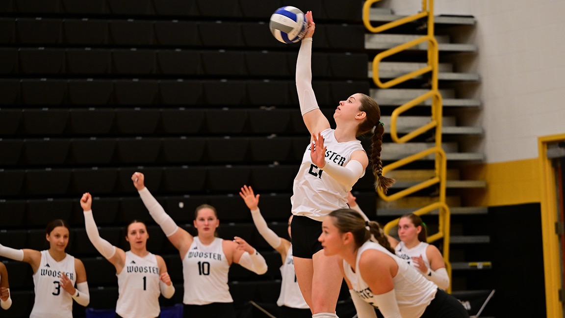 Kora Burill serves with the ball in her right hand